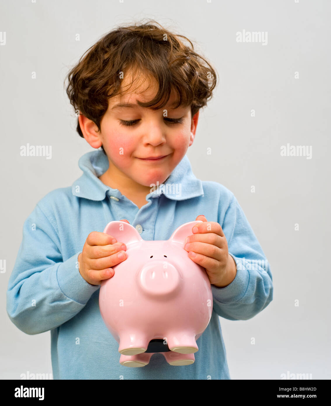 young boy holding a piggy bank Stock Photo - Alamy