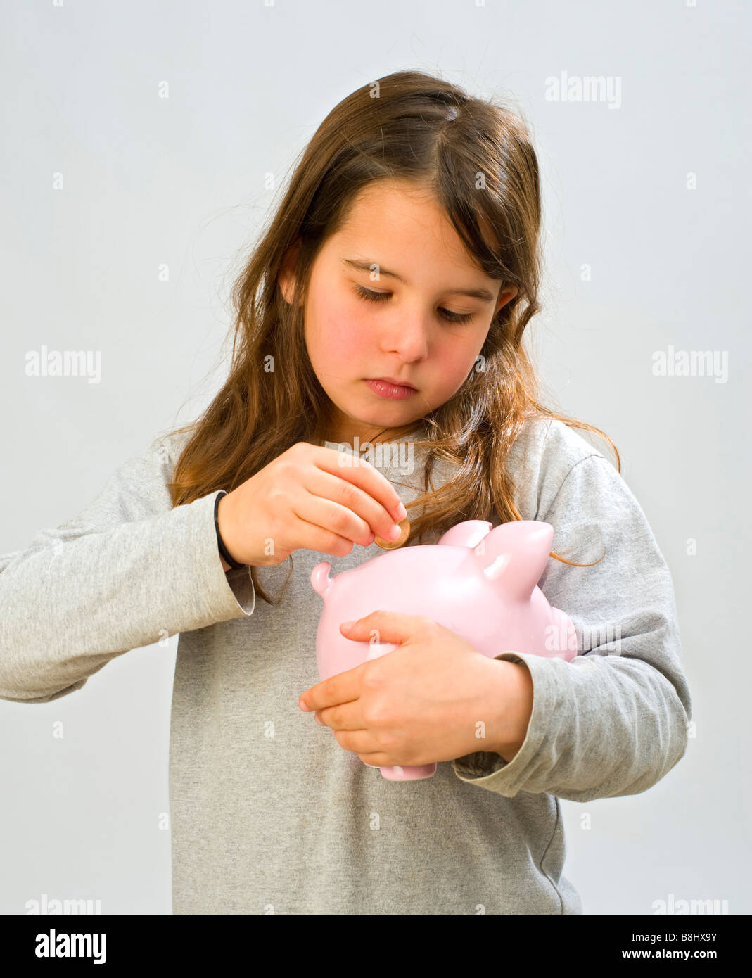 girl holding a piggy bank Stock Photo - Alamy