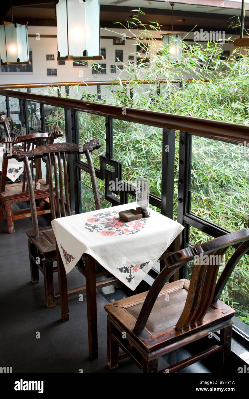 Old tables and chairs at a modern courtyard teahouse in Chengdu in ...