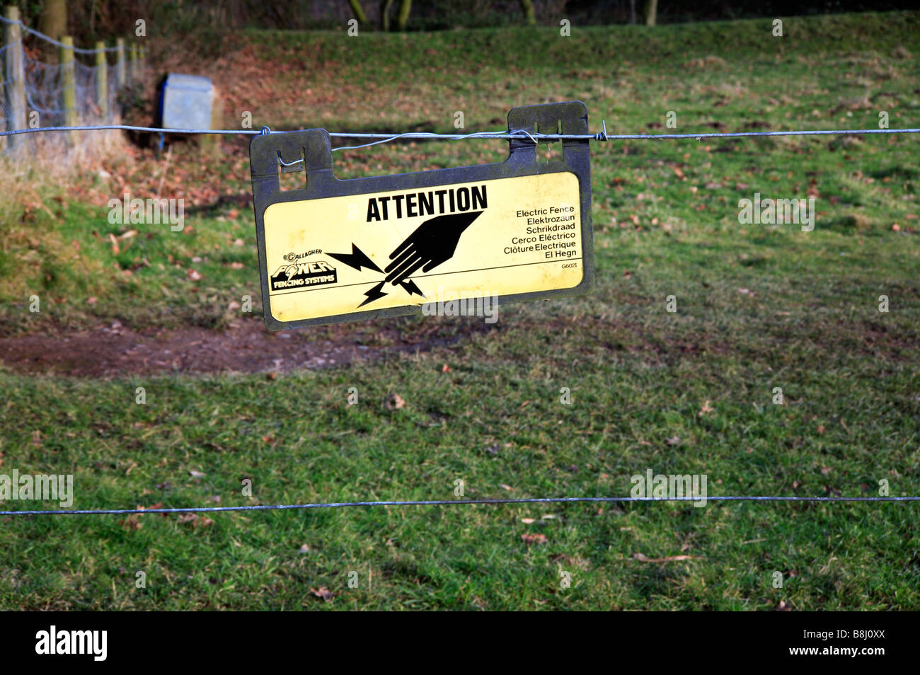 Warning sign for an electrified fence on farmland. Stock Photo