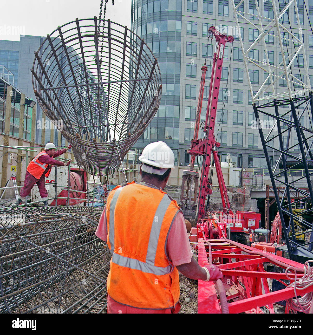 Contractors lifting steel reinforcement cage used to provide additional
