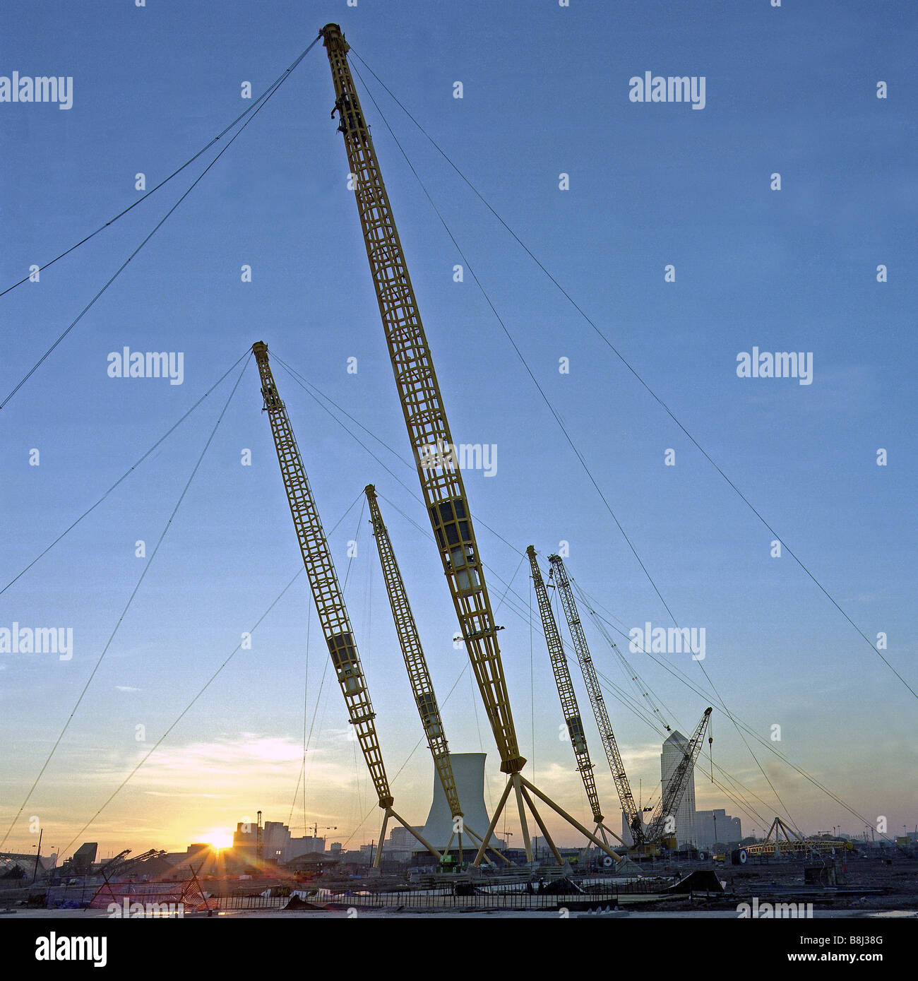 Contractors positioning the huge 100 metre support masts during the building of the Millennium Dome/O2 Arena in London, UK. Stock Photo