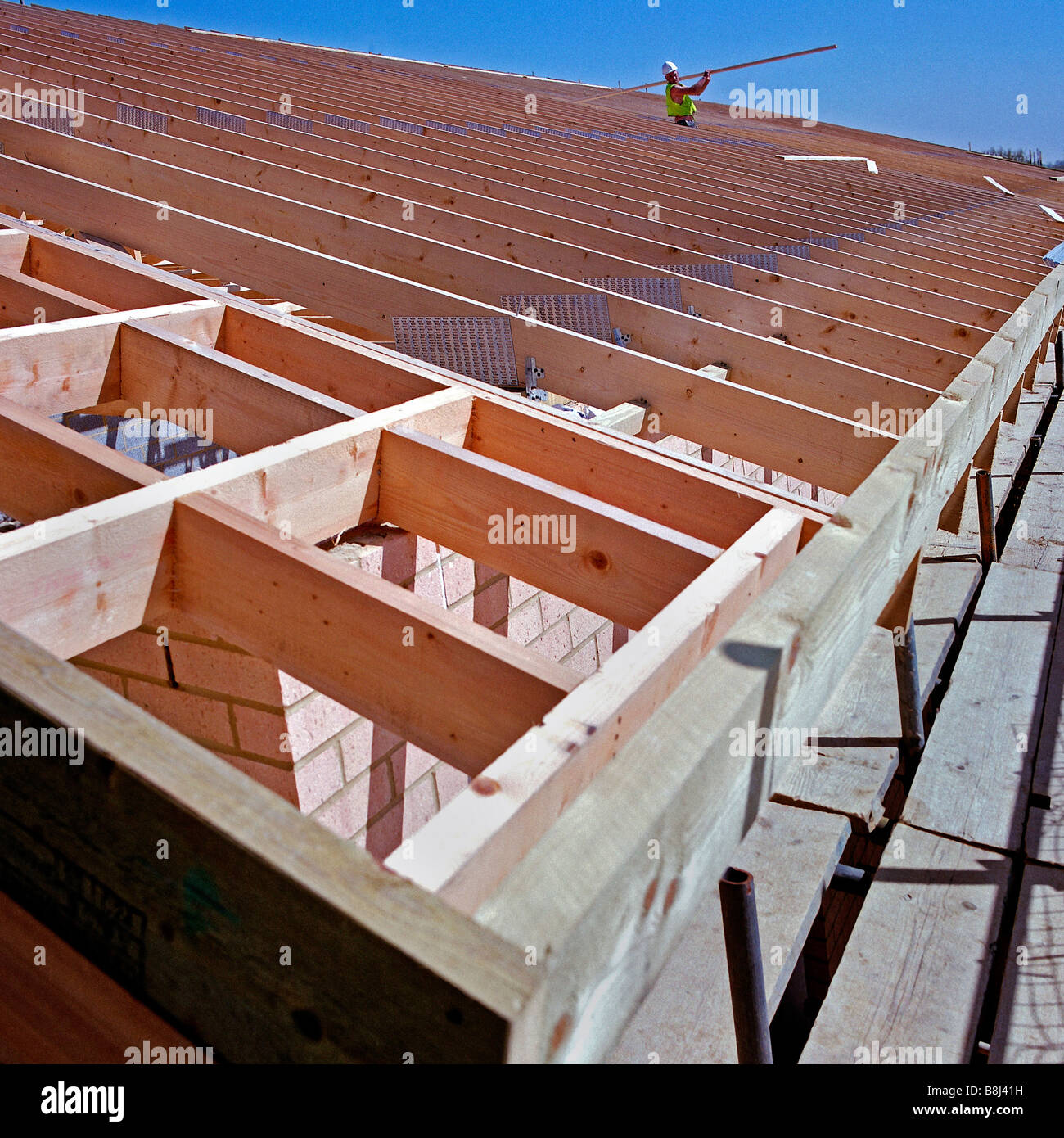 Contractor carrying diagonal brace strut to join prefabricated roof Stock Photo 22525933 Alamy