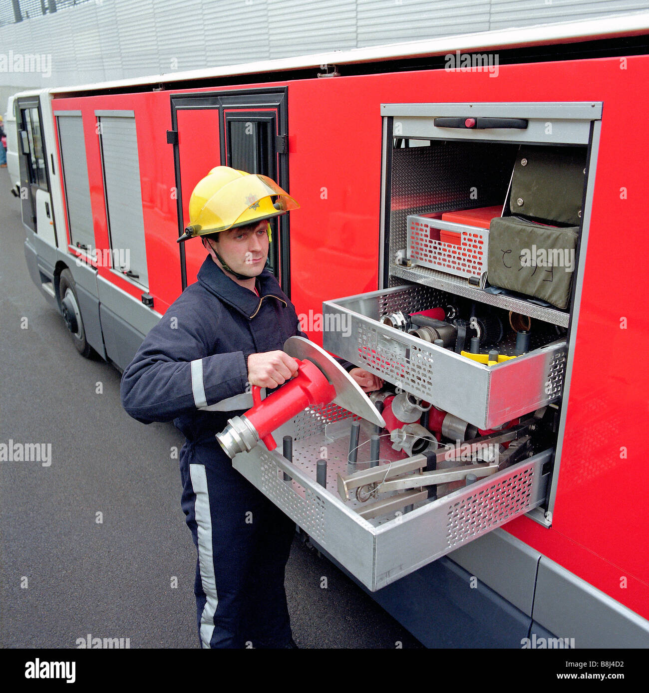 Firefighter selects equipment from a specially designed STTS vehicle in