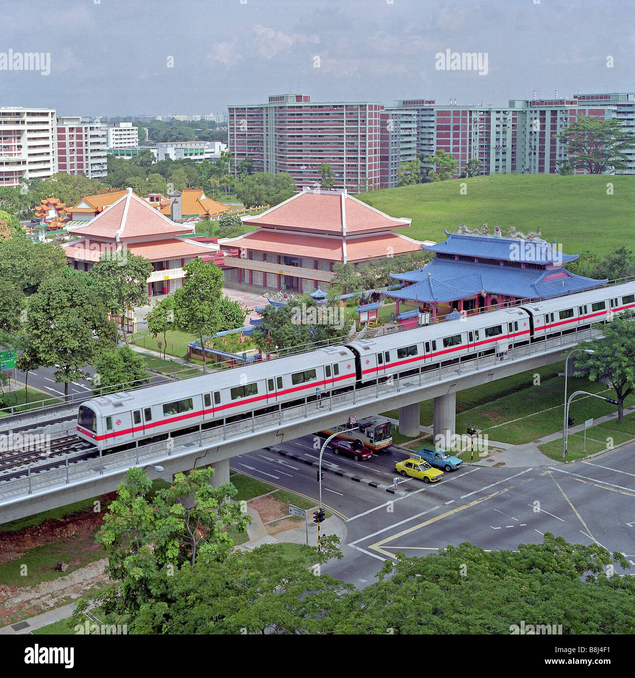 Train on elevated section of Singapore's Mass Rapid Transit which transports huge numbers of passengers with speed and safety. Stock Photo