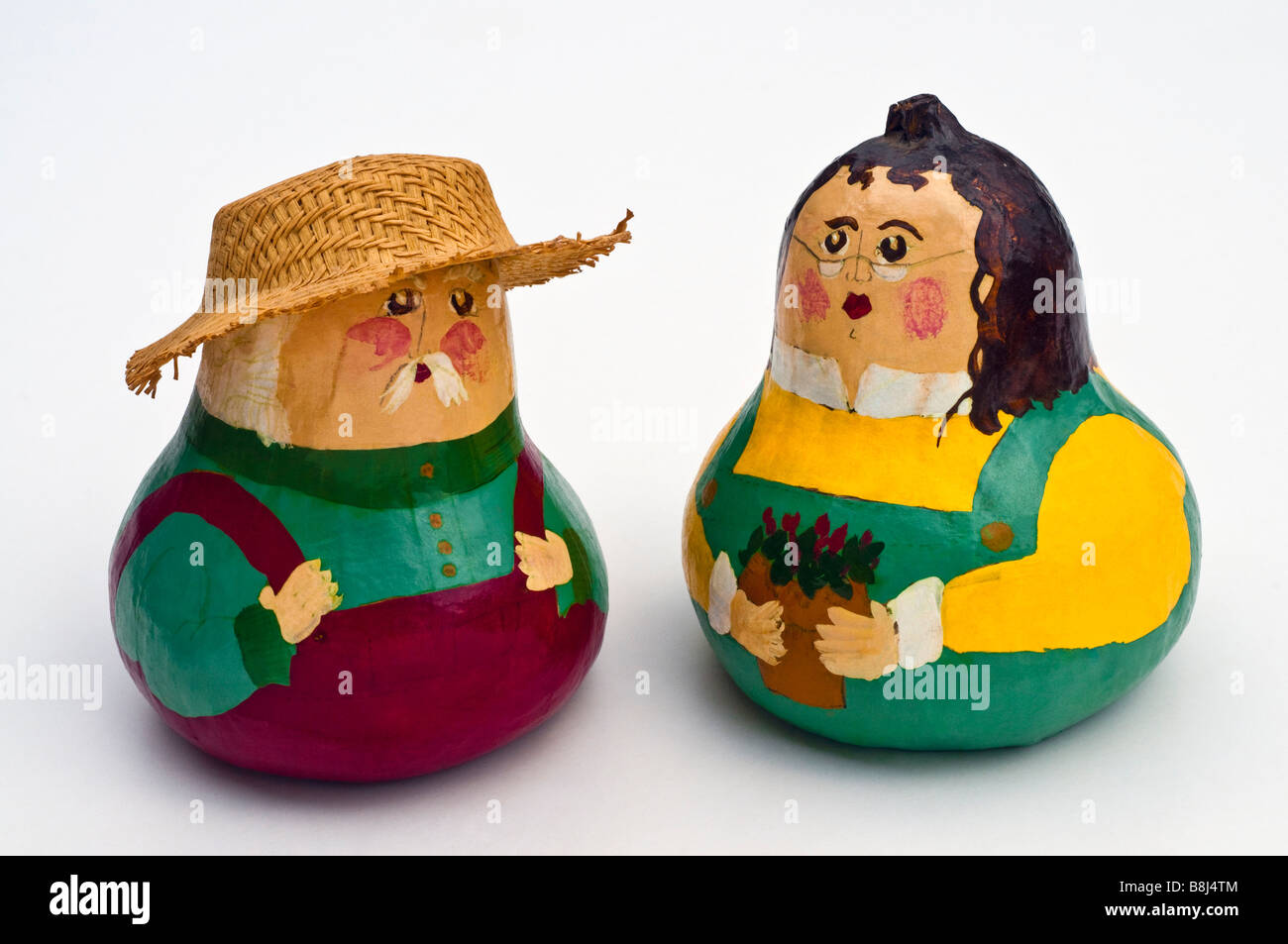 Man and woman model figures made from painted vegetable gourds - American. Stock Photo