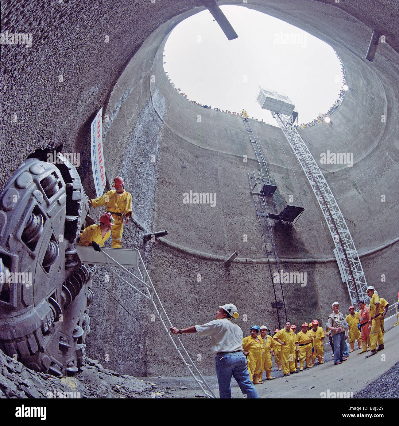 Contractors celebrating breakthrough of a boring machine excavating a water tunnel, into access shaft at a reservoir in Ecuador. Stock Photo