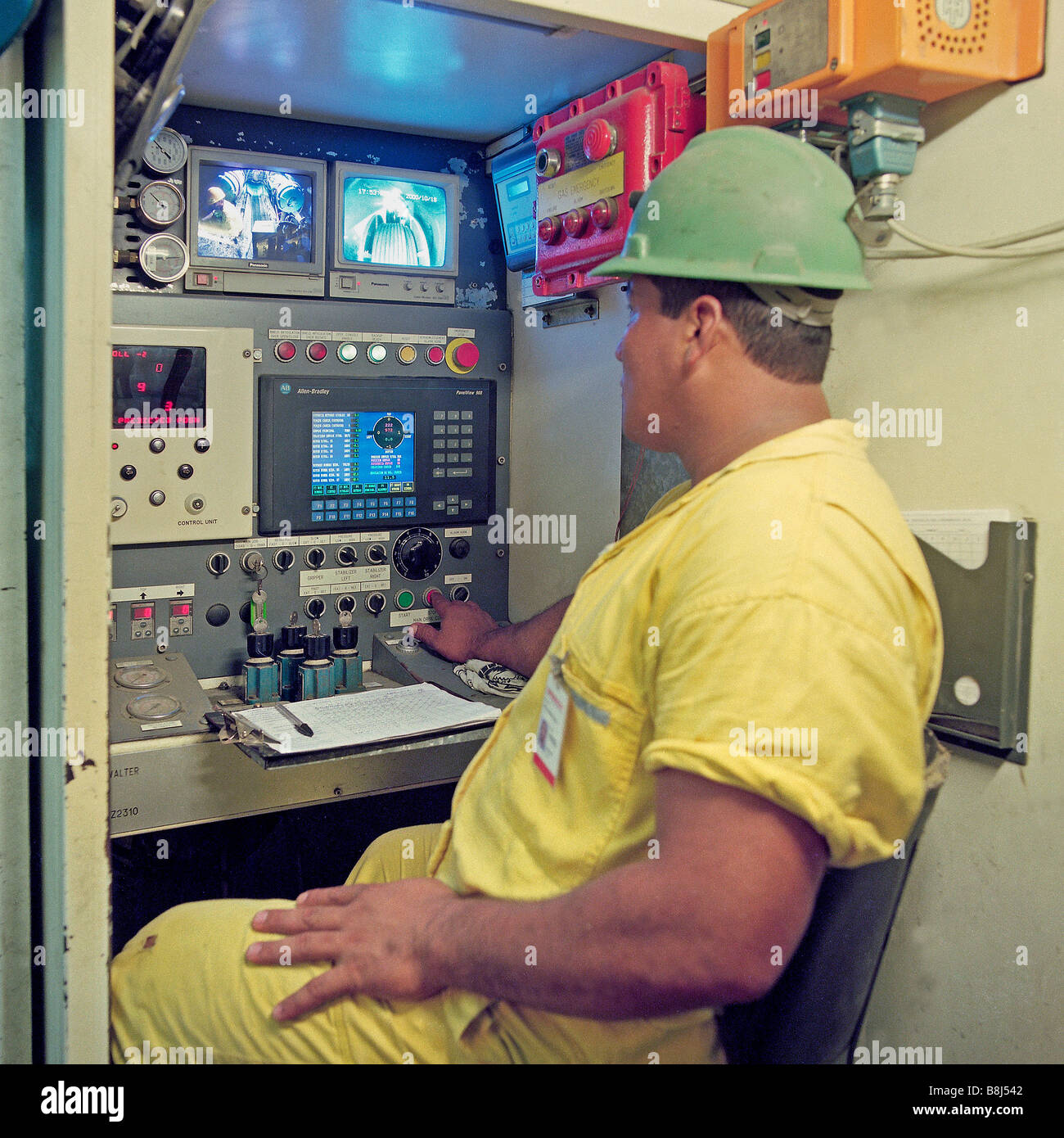Driver in control cabin of Tunnel Boring Machine which is excavating a water tunnel in Ecuador