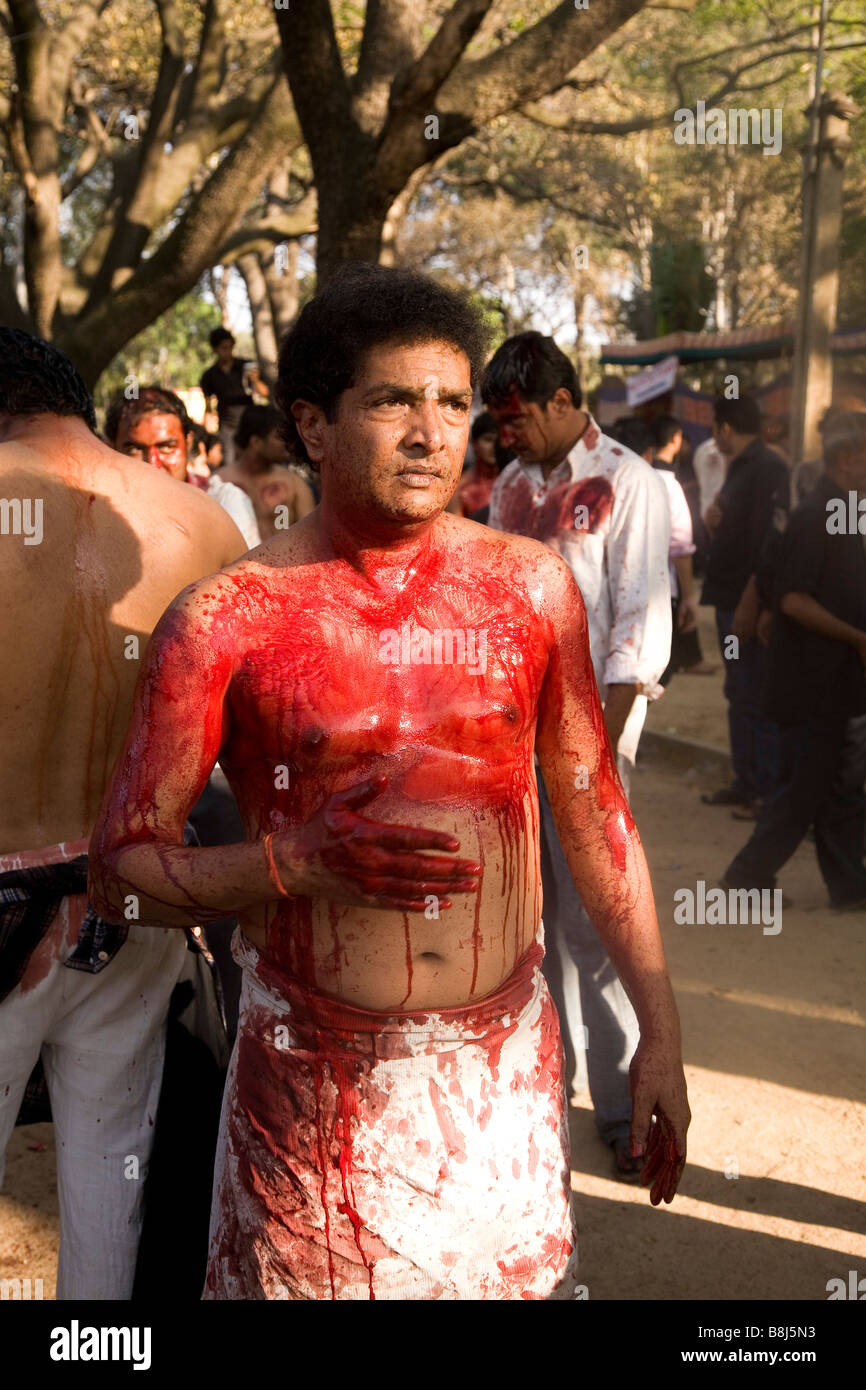 A man bleeds among a gathering of Shia Muslims, celebrating Day of Ashura (festival of Karbala, a.k.a Moharra) in Bangalore. Stock Photo
