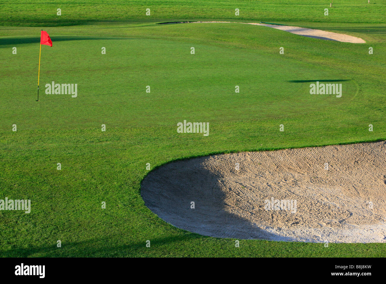 golf course fairway sand bunker red and green abstract image sand pit red  flag Stock Photo - Alamy