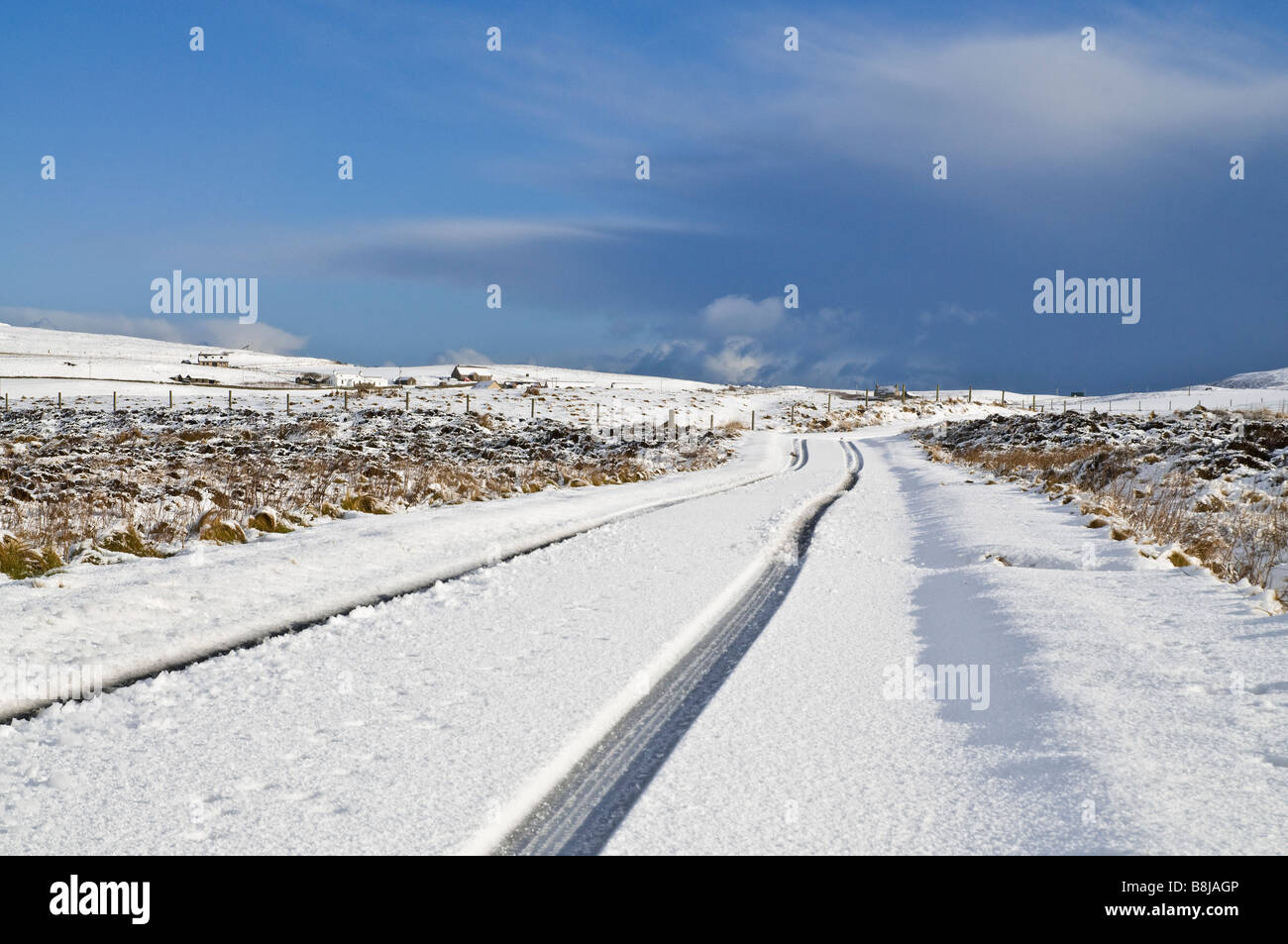 dh  ROADS UK Scotland Icy snowy road snow fields tyre tracks Orkney winter marks on open road country lane Stock Photo