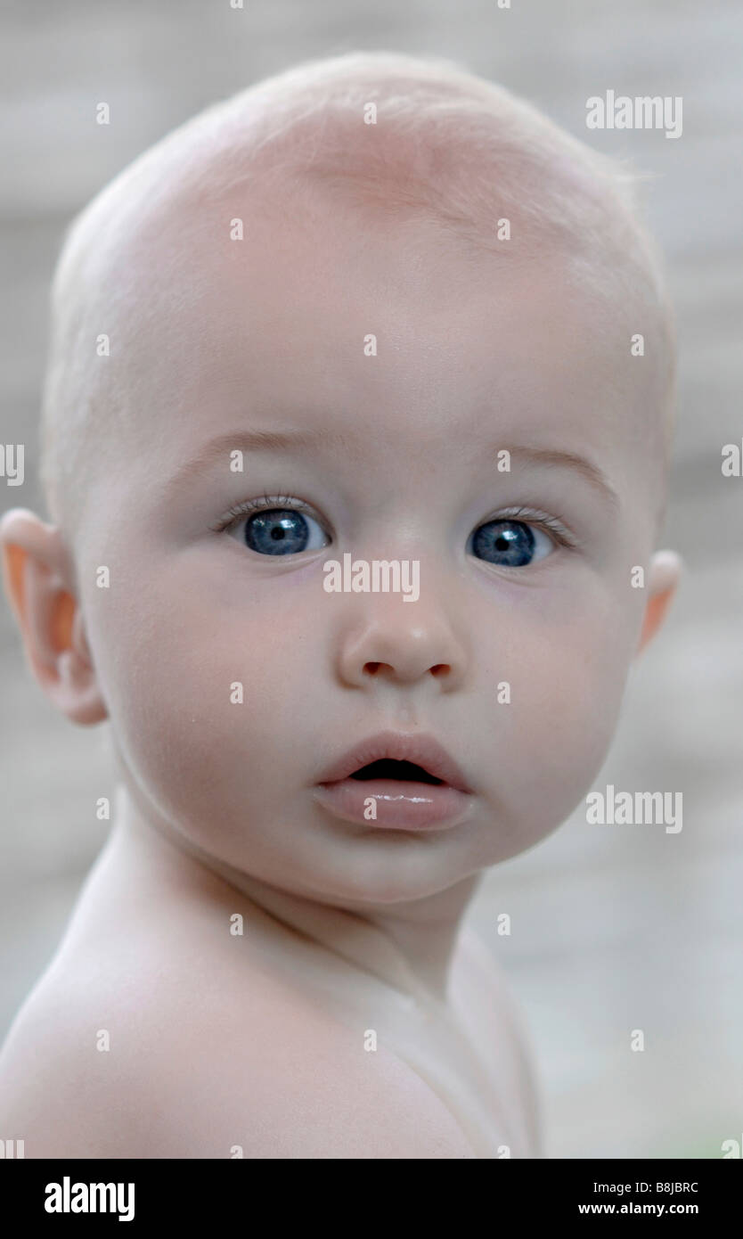 A baby boy with blue eyes looks into the camera Stock Photo - Alamy