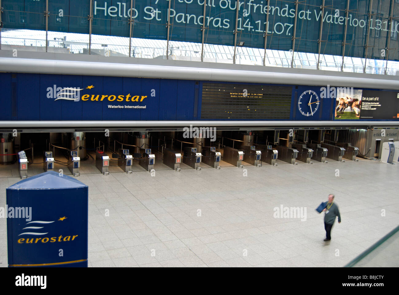 a man walks across the deserted former eurostar terminal at waterloo station, london, shortly after services were transferred Stock Photo