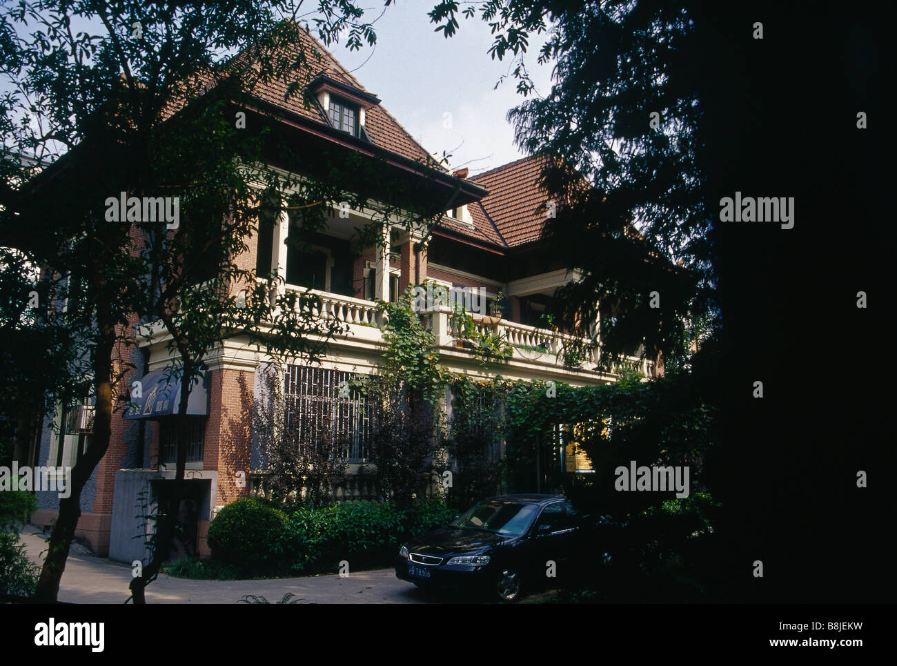 ╘French concession' area Old house European style brick windows Large verandah Car parked SHANGHAI CHINA Stock Photo