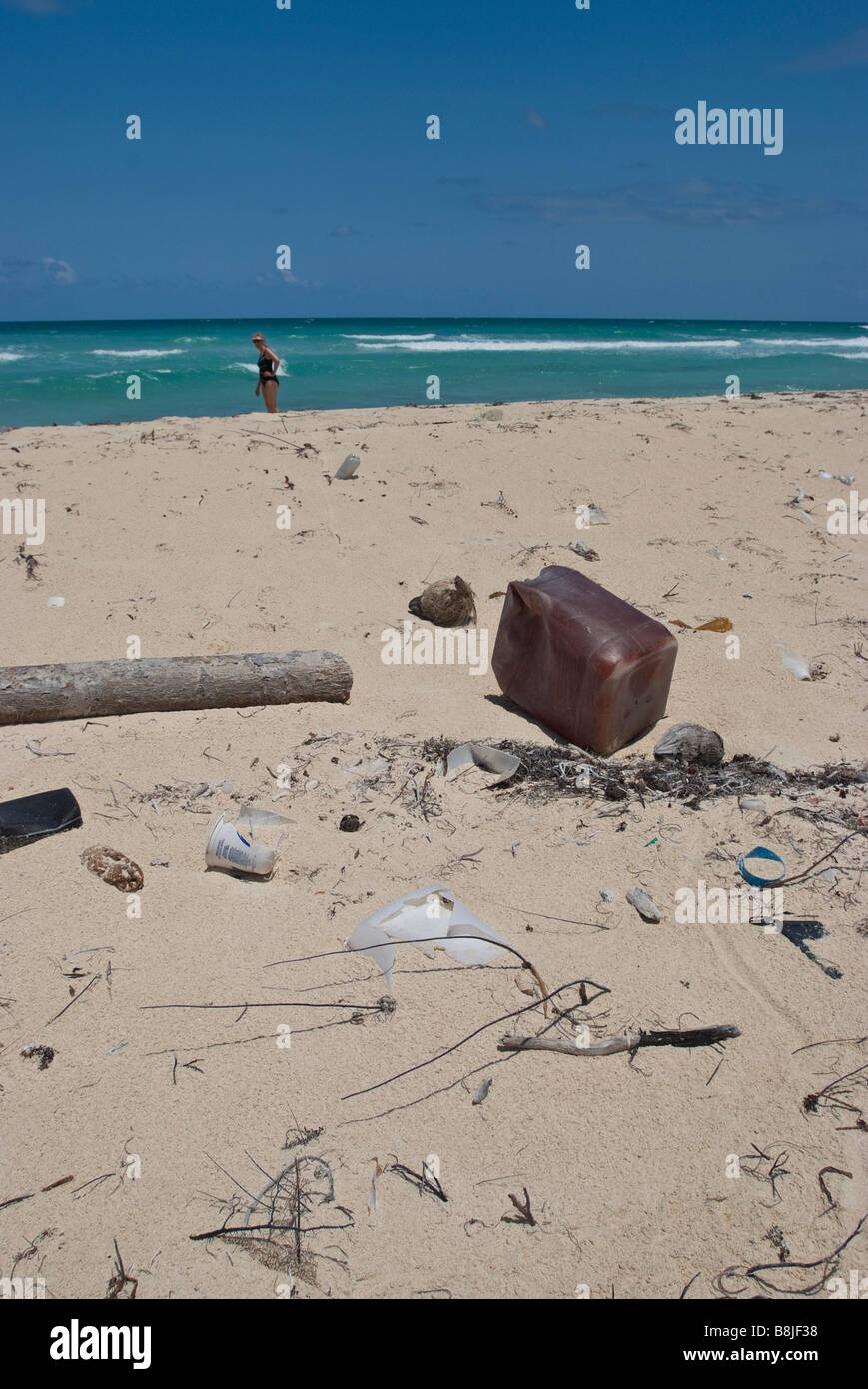 Plastic trash washed ashore on the white sand beach near Tulum Mexico. Stock Photo