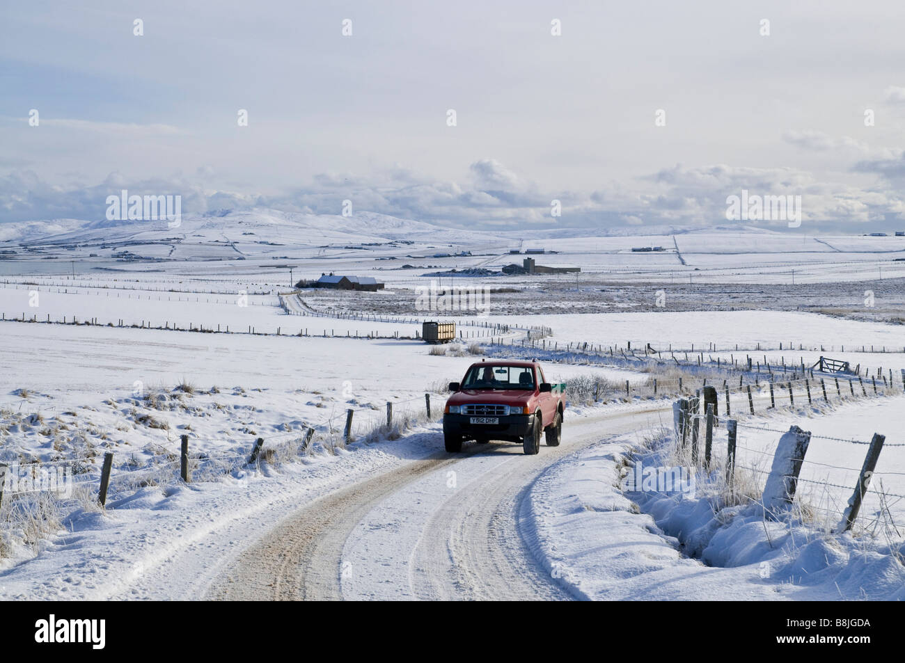 dh Scotland winter ROADS UK Farmers truck on icy snow roads car orkney motorist snowy winter rural road Stock Photo