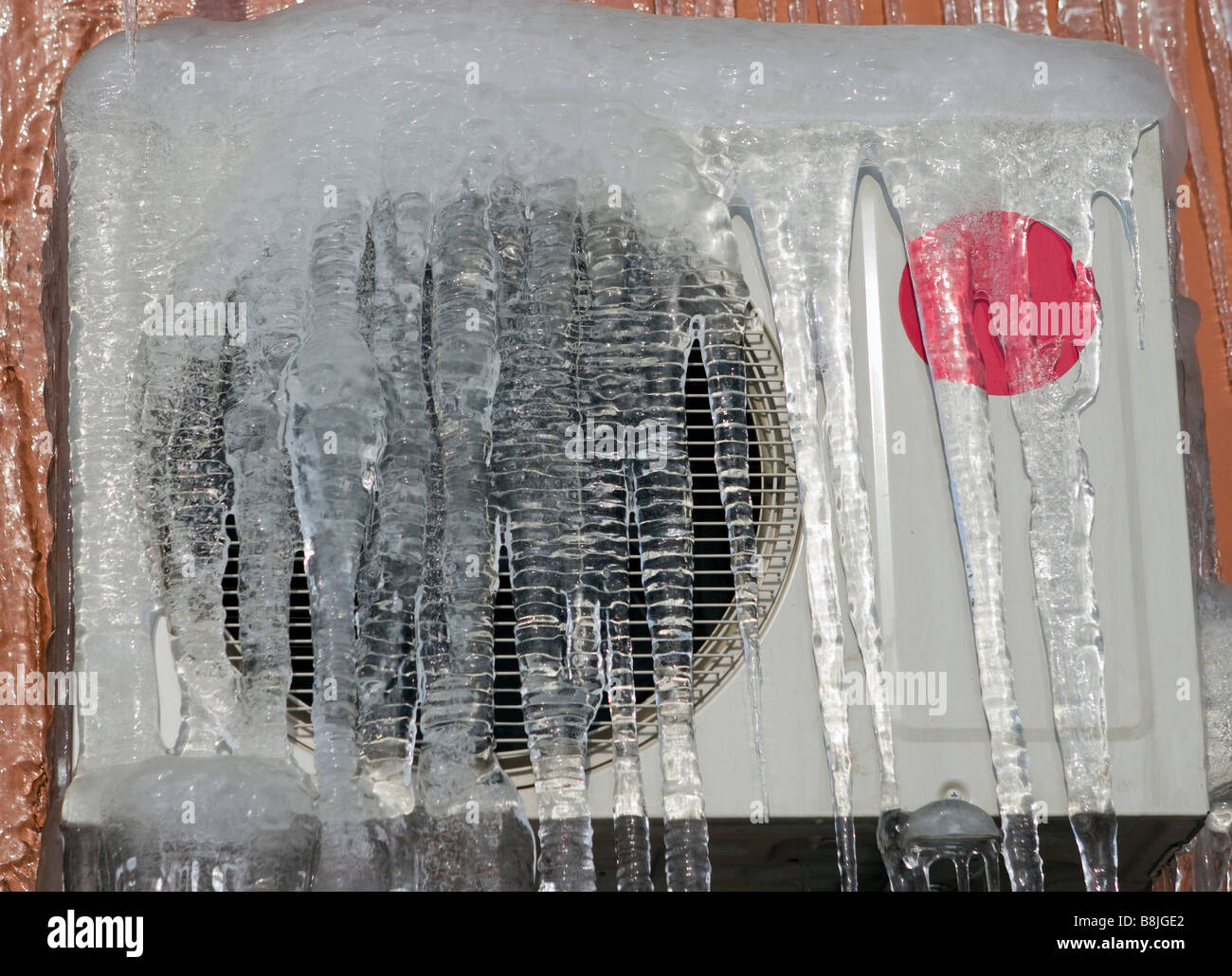 Broken air conditioner covered with ice. Stock Photo