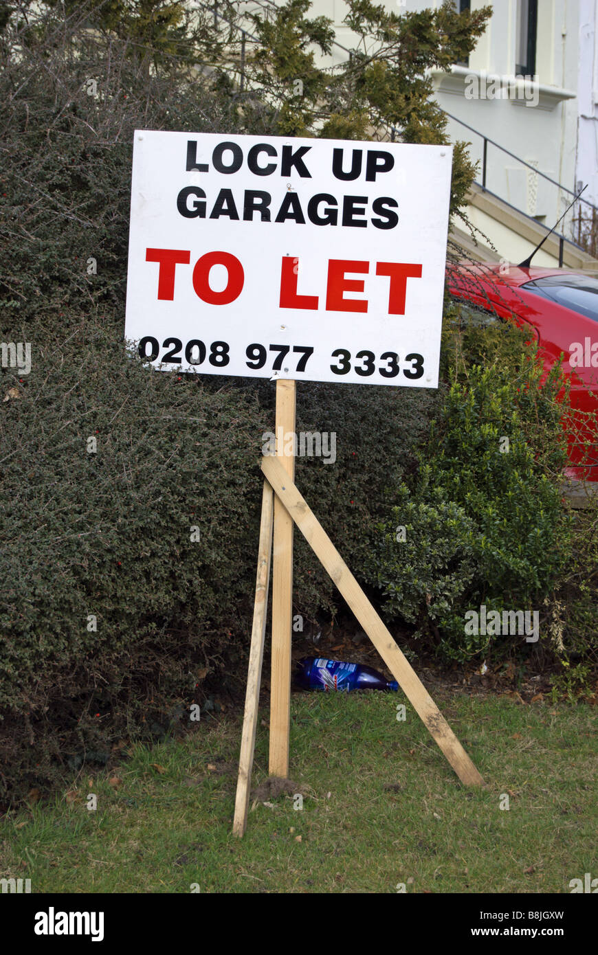 lock up garages to let sign on a wooden pole in a residential street in