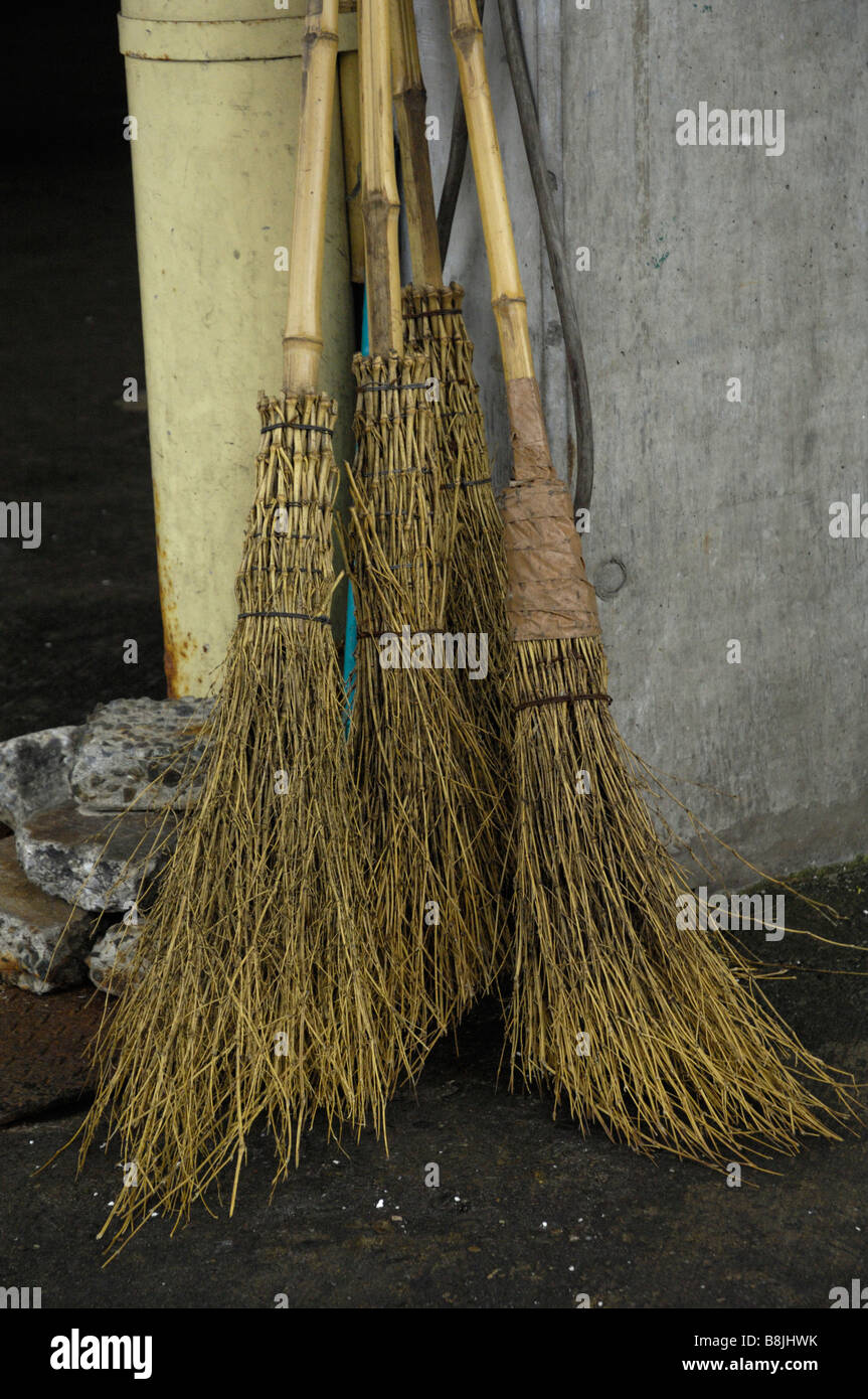 Traditional bamboo brooms lean against the wall at Tokyo's Tsukiji fish