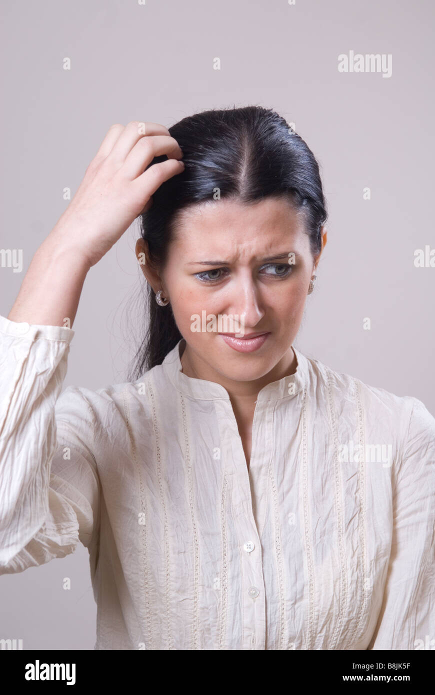 Woman scratching head Stock Photo Alamy