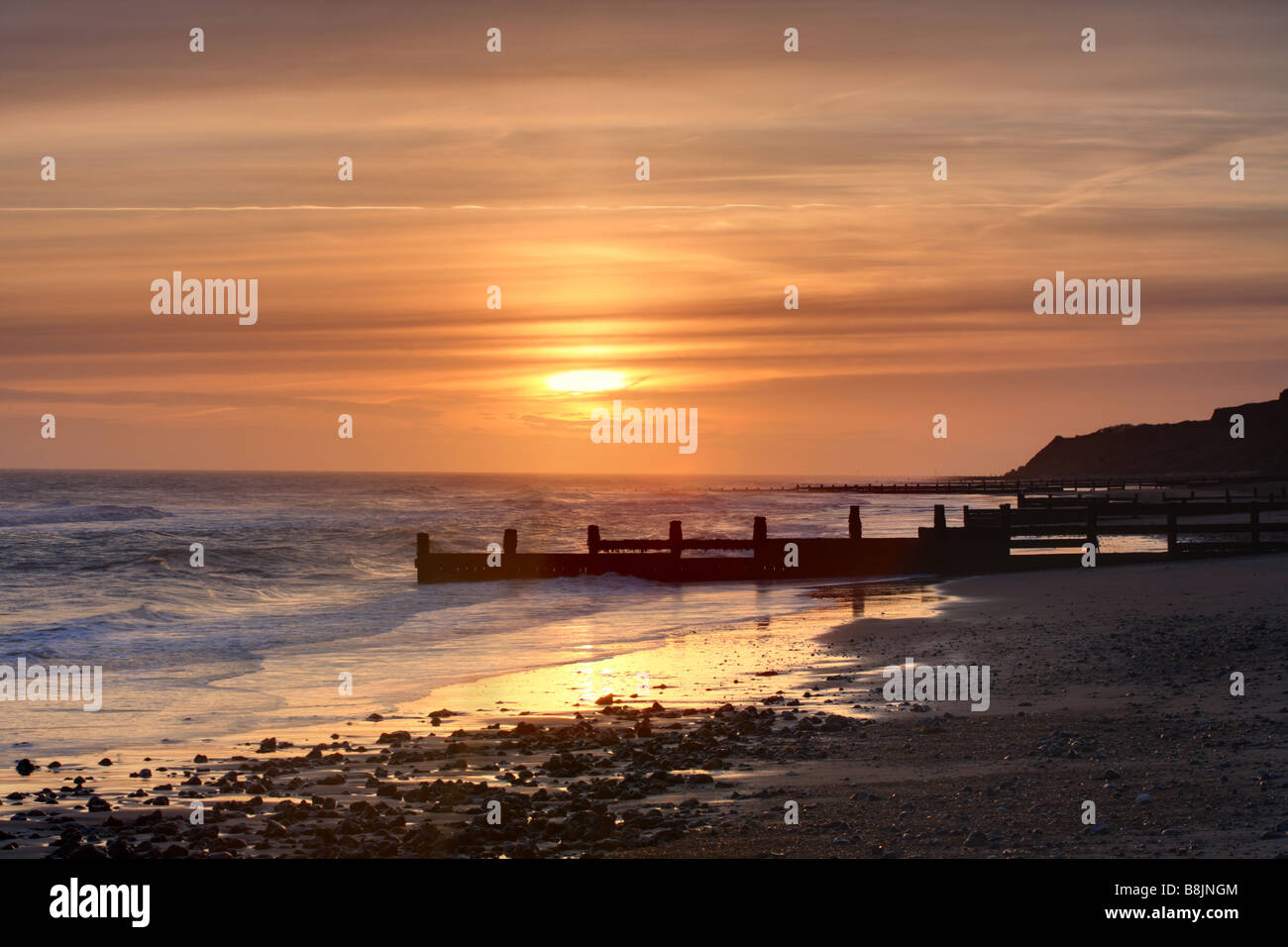 'Sunrise at Cromer' 'Norfolk' 'East Anglia' beach and sea with groyne in the distance. Stock Photo