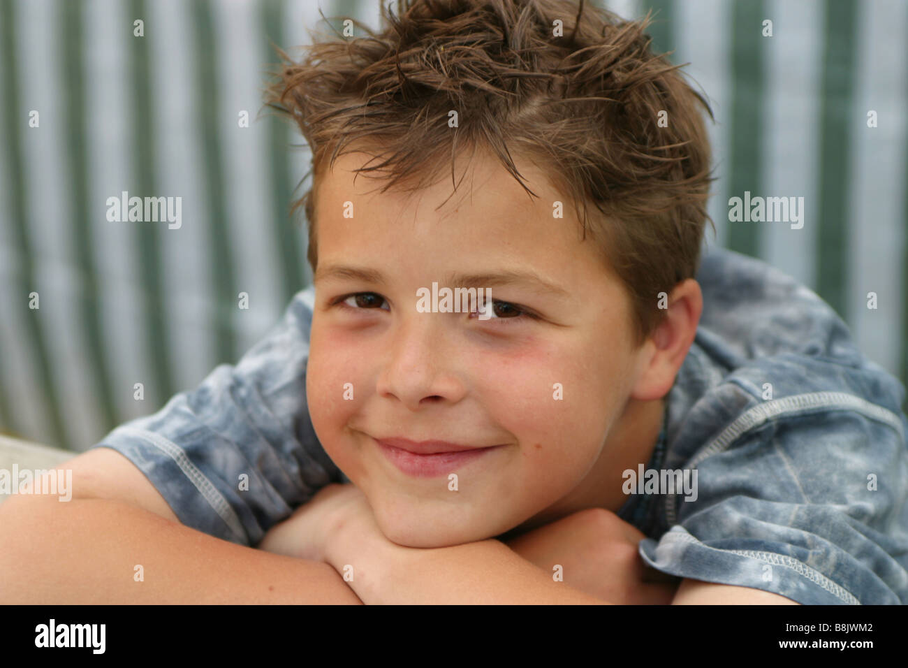 Portrait relaxed young boy, 9 years old,  smiling and look at camera, satisfied preteen. Stock Photo