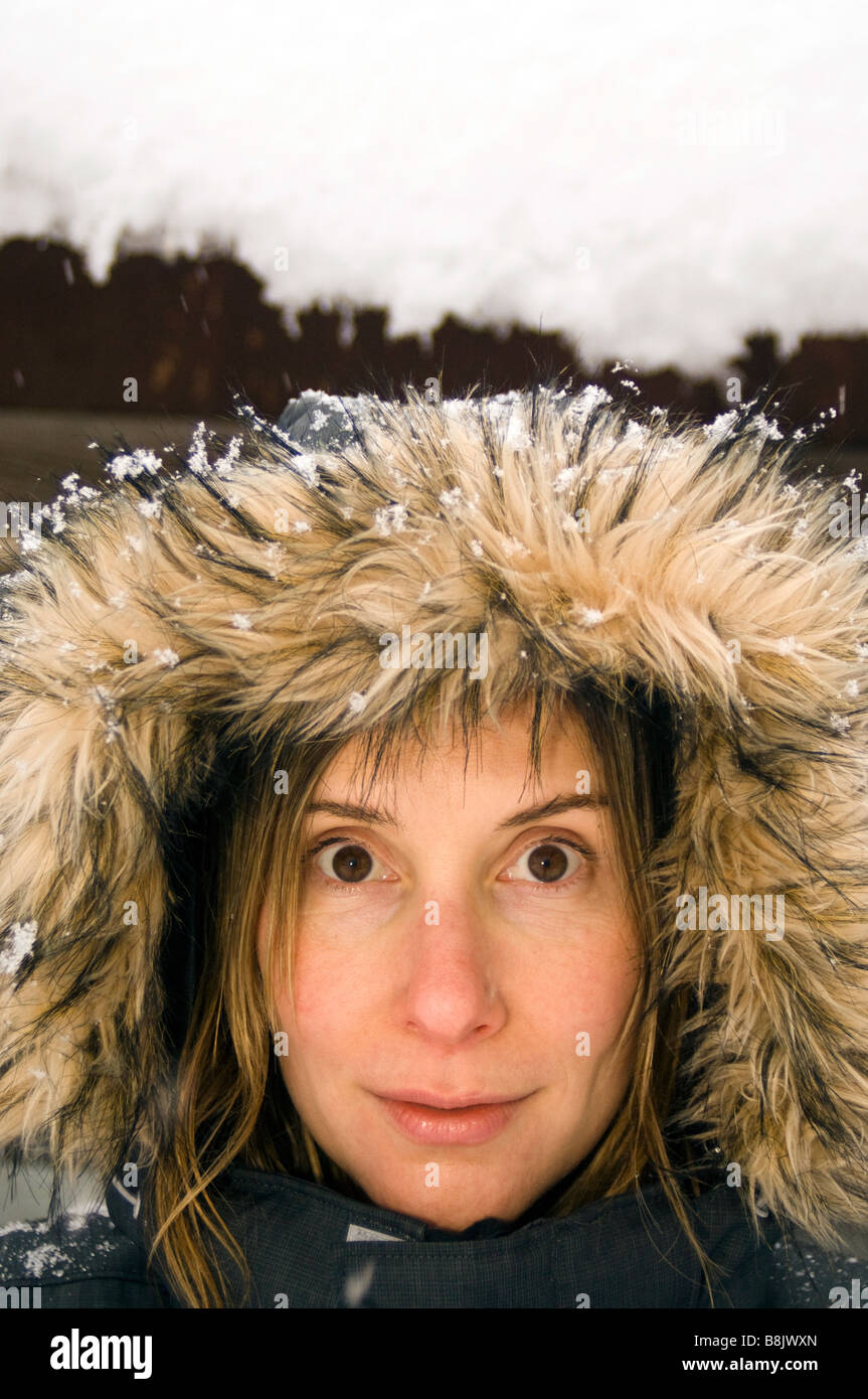 A Woman With A Fur Hood On A Snowy Winter Day Whitefish MT Stock a-woman-with-a-fur-hood-on-a-snowy-winter-day-whitefish-mt-stock