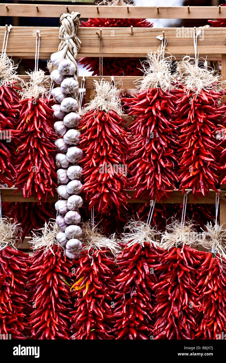Chili ristras and braids of garlic displayed in outdoor market in Santa Fe, New Mexico Stock Photo