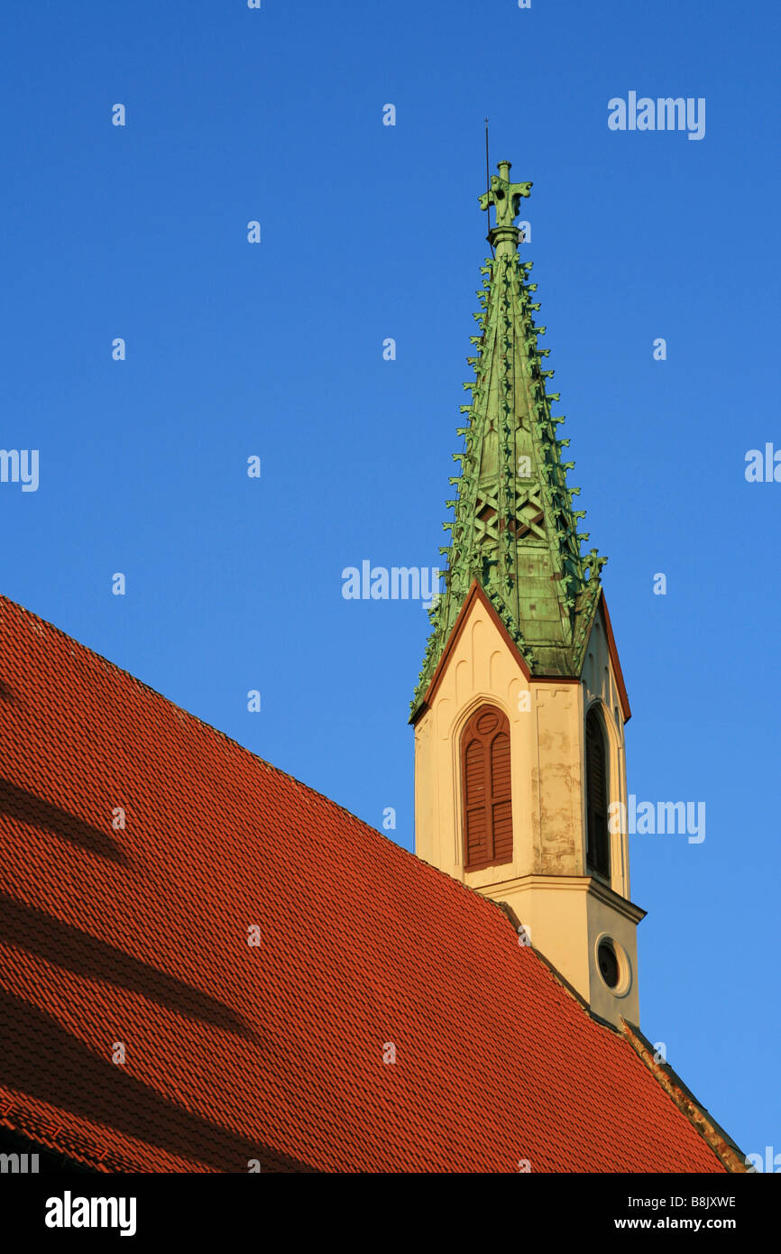 Sunset rays cast shadows on the roof of St. John's Church, in Riga ...