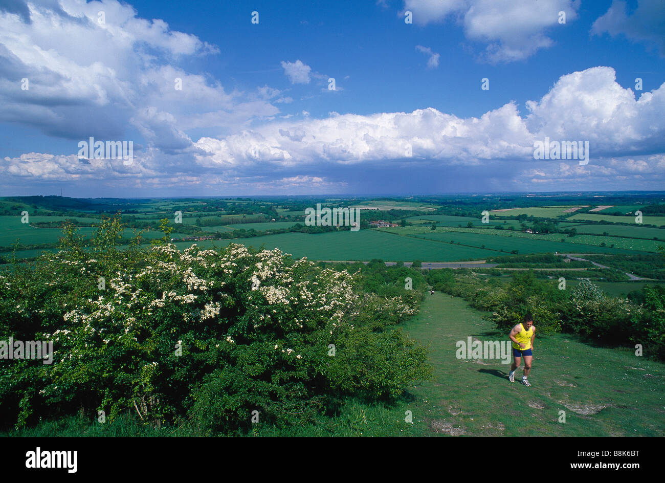 Near Old Burghclere View across landscape Chalk escarpment Walking path Person jogging running