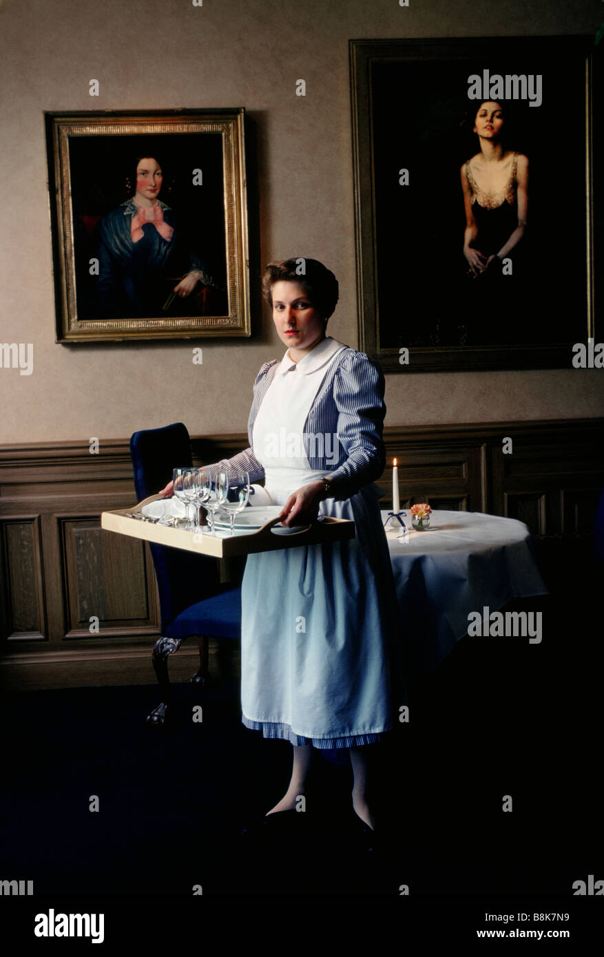 Devonshire Gardens Hotel Glasgow Scotland A member of staff sets out the dining room for lunch Stock Photo