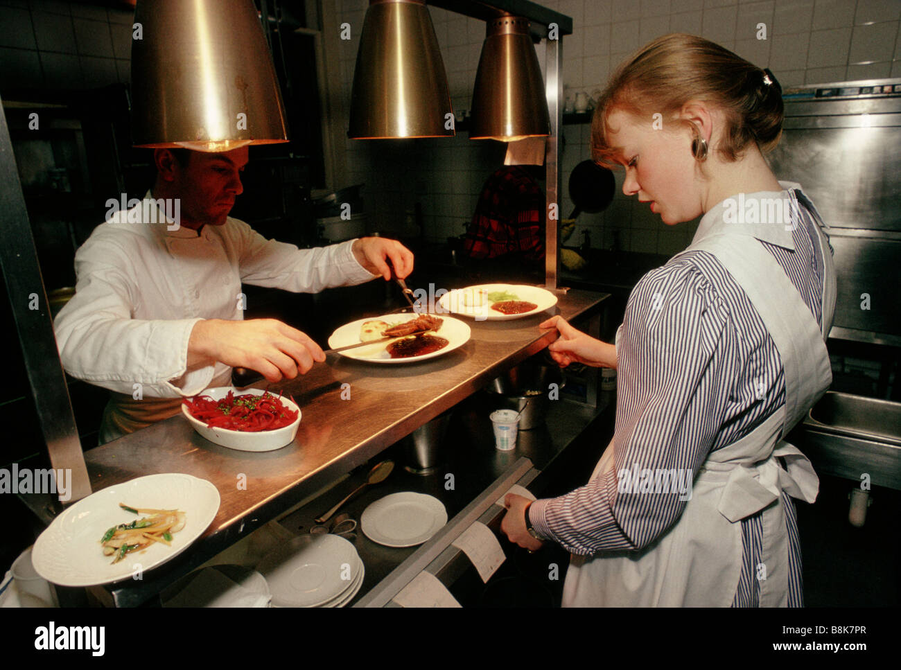 Devonshire Gardens Hotel Glasgow Scotland. A waitress collects orders from the kitchen Stock Photo
