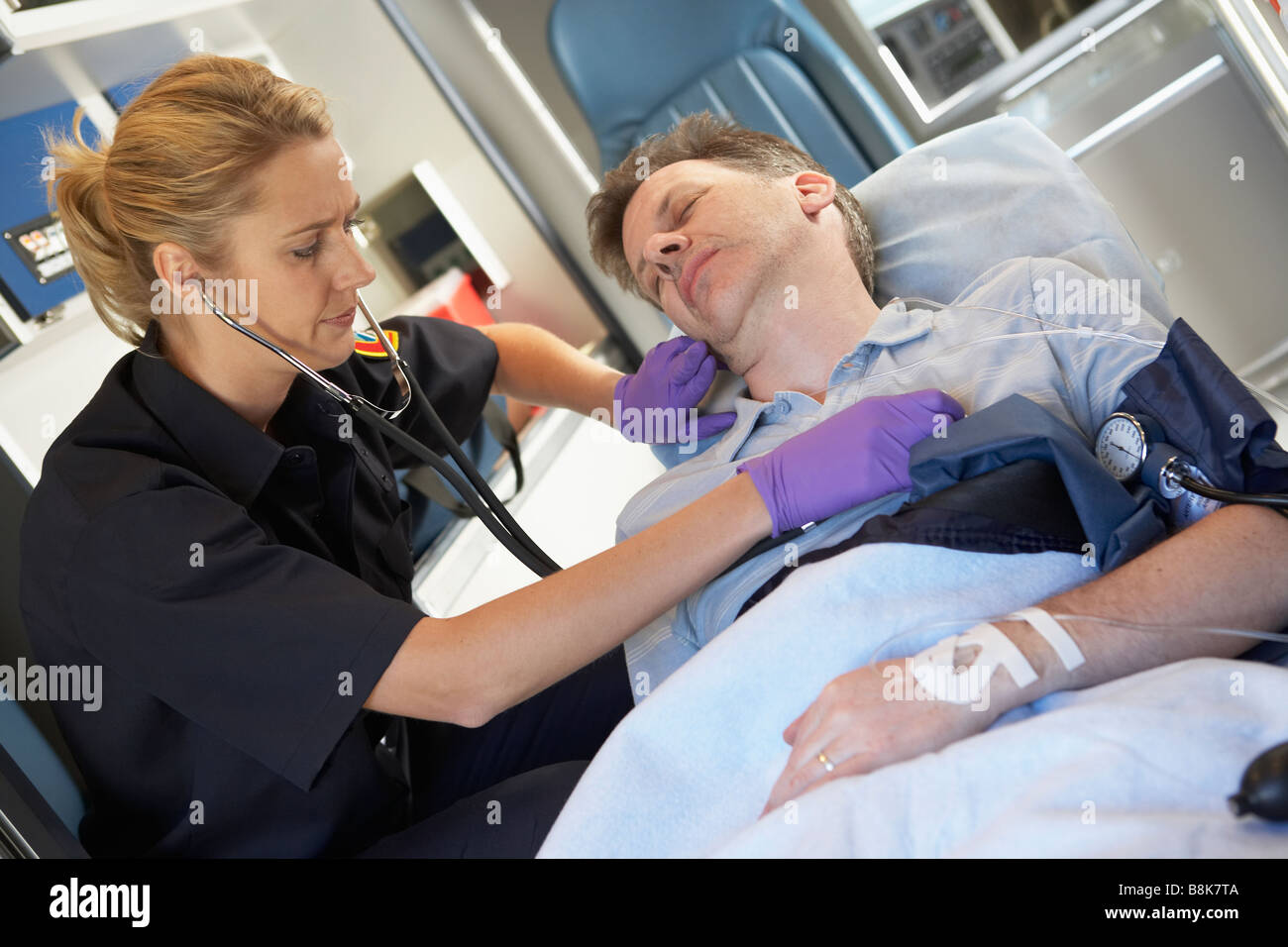 Paramedic attending to patient in ambulance Stock Photo Alamy