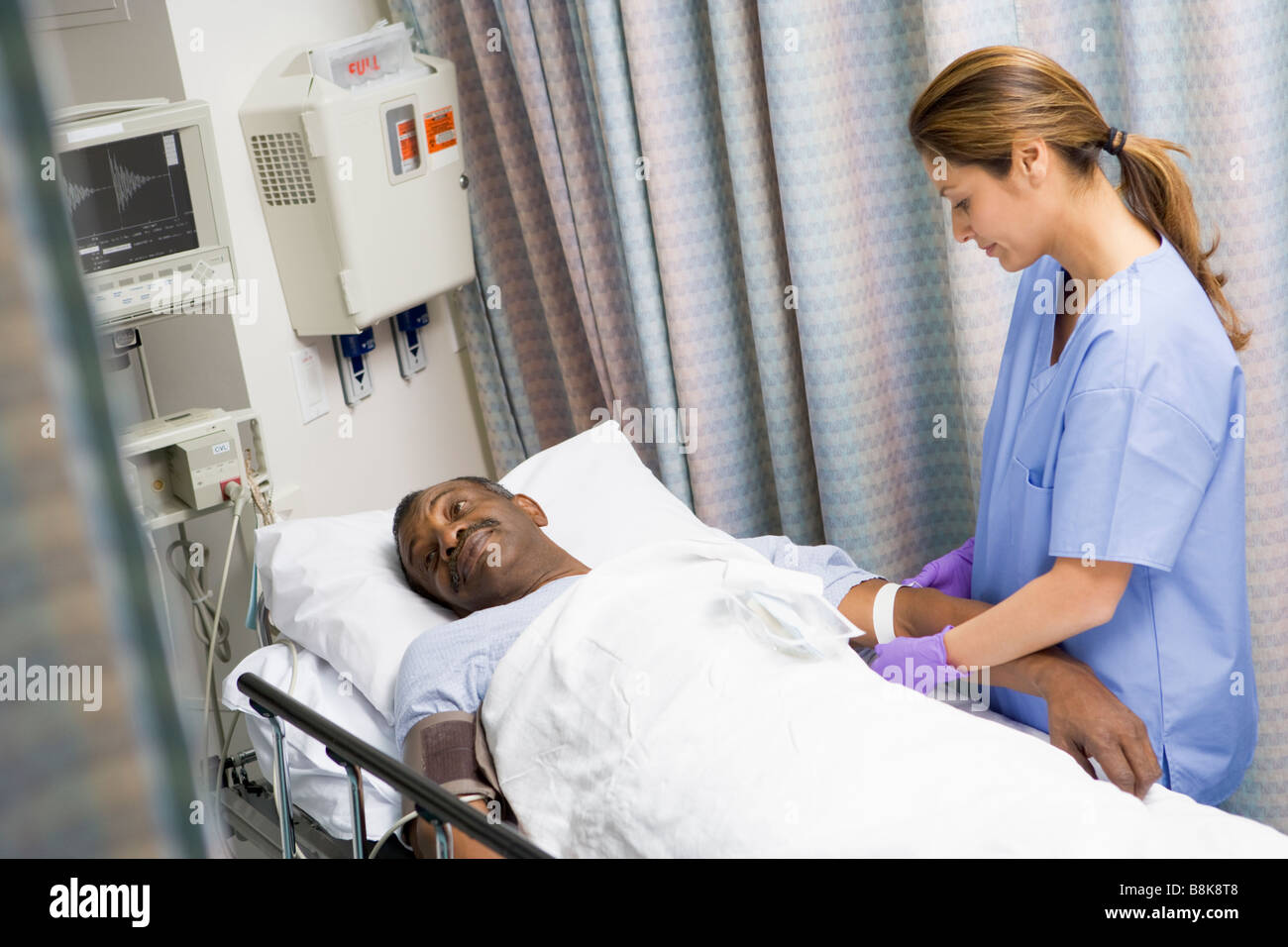 Nurse Caring For Patient Stock Photo
