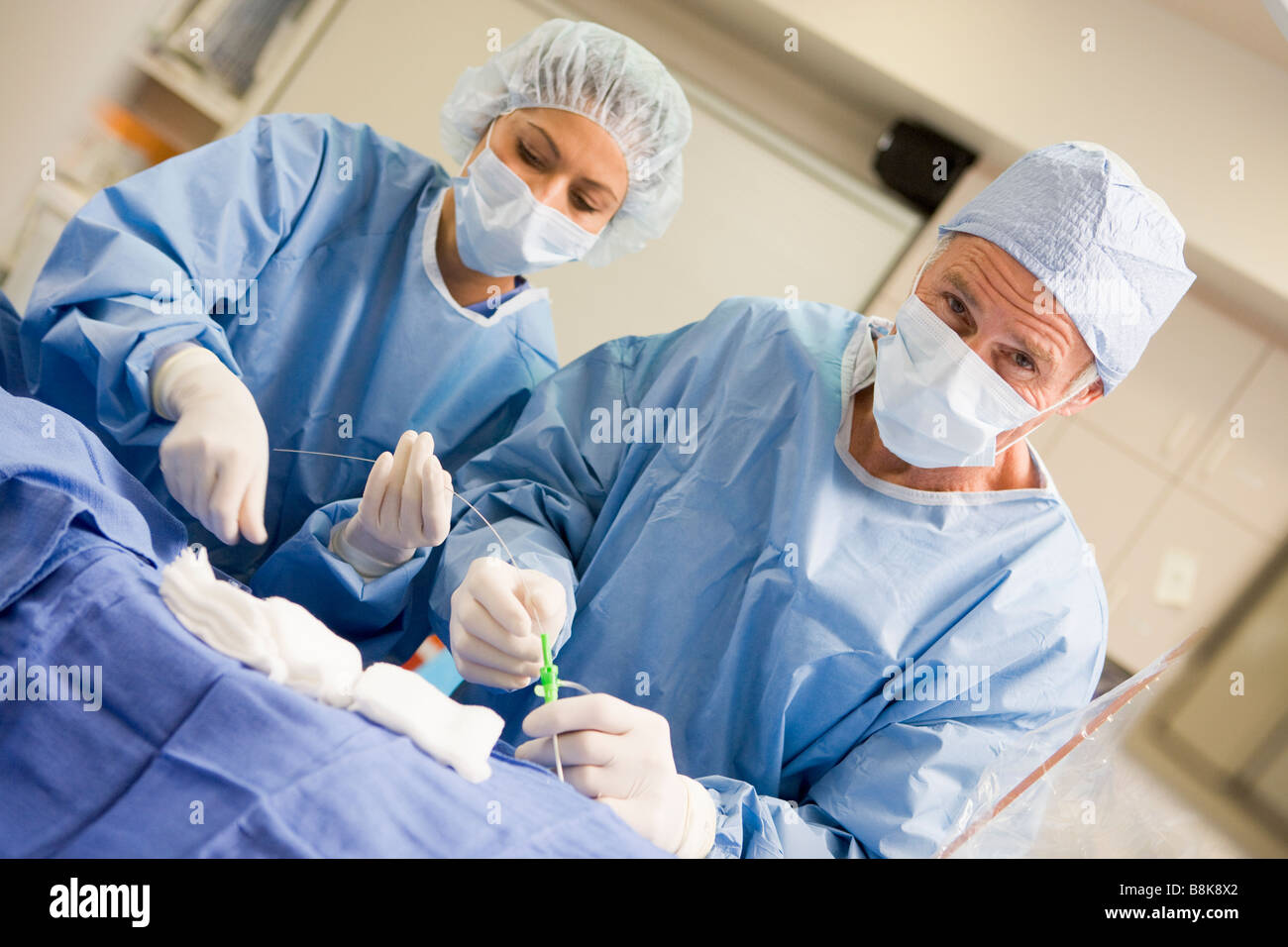 Surgeons Preparing Equipment For Surgery Stock Photo