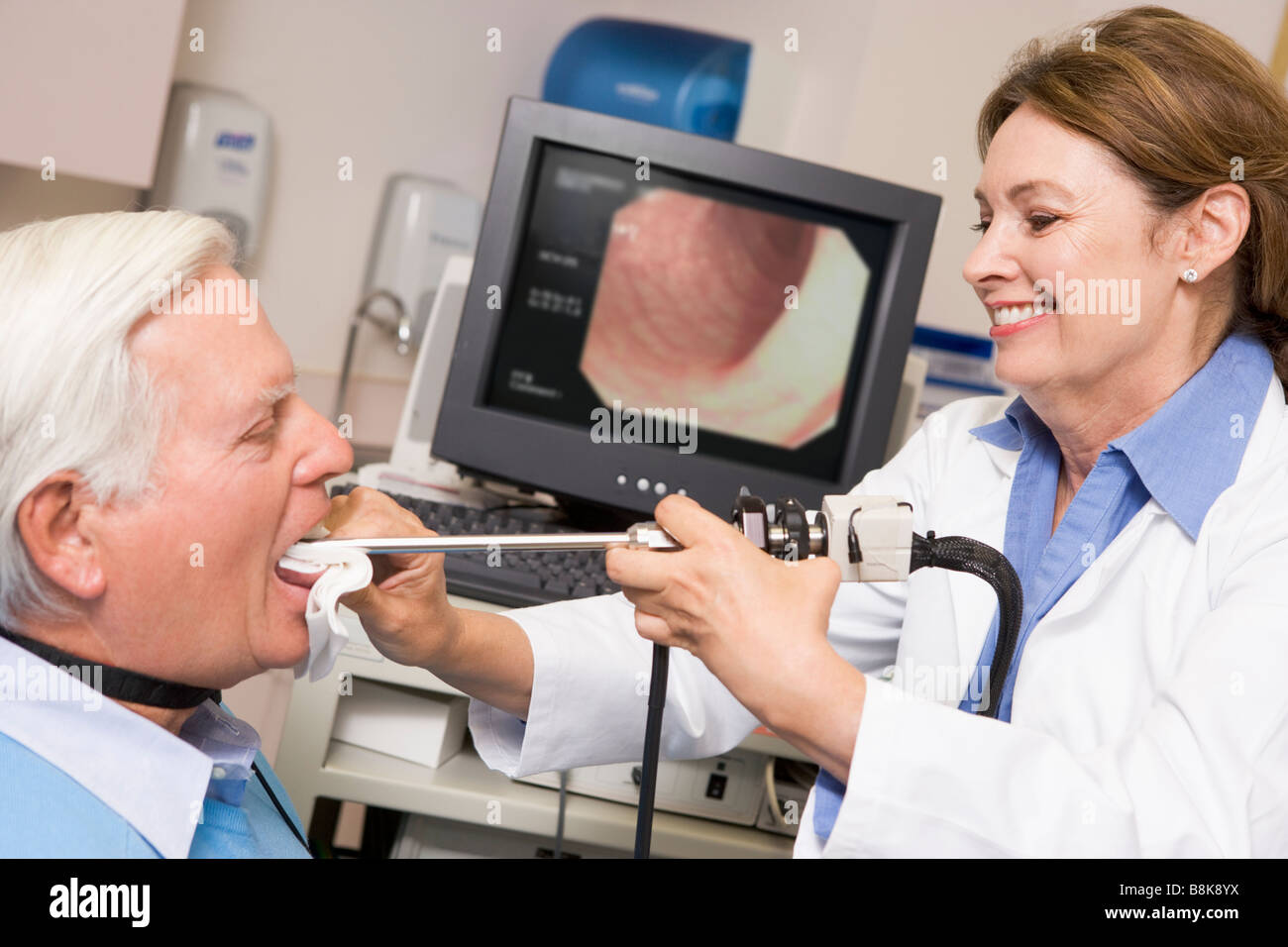 Using Dr. Check Doctor Performing Check-Up On Patient Stock Photo - Alamy