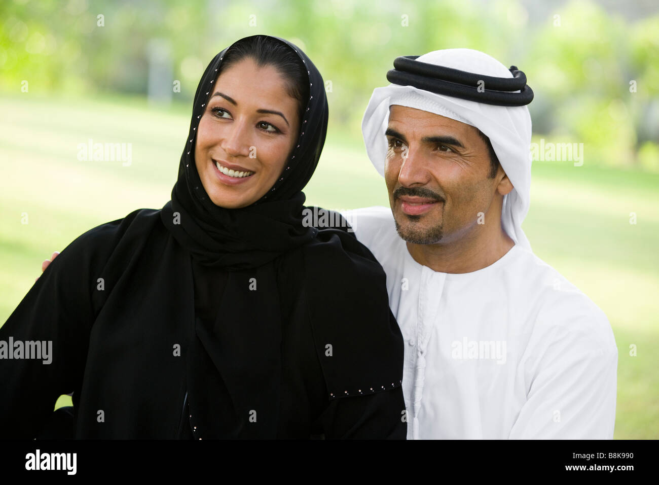 Couple outdoors in park smiling (selective focus) Stock Photo