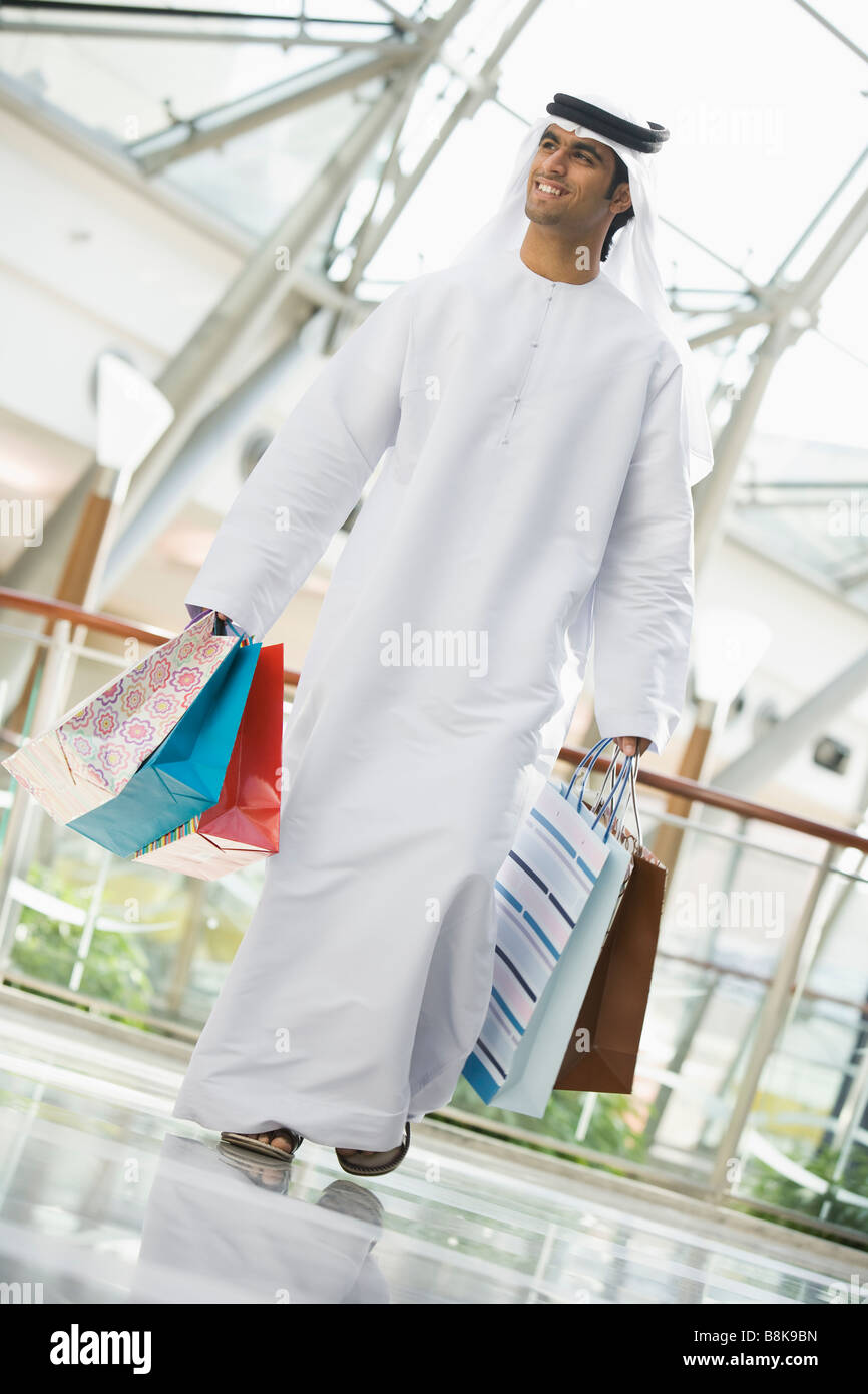 Man walking in mall smiling (selective focus) Stock Photo