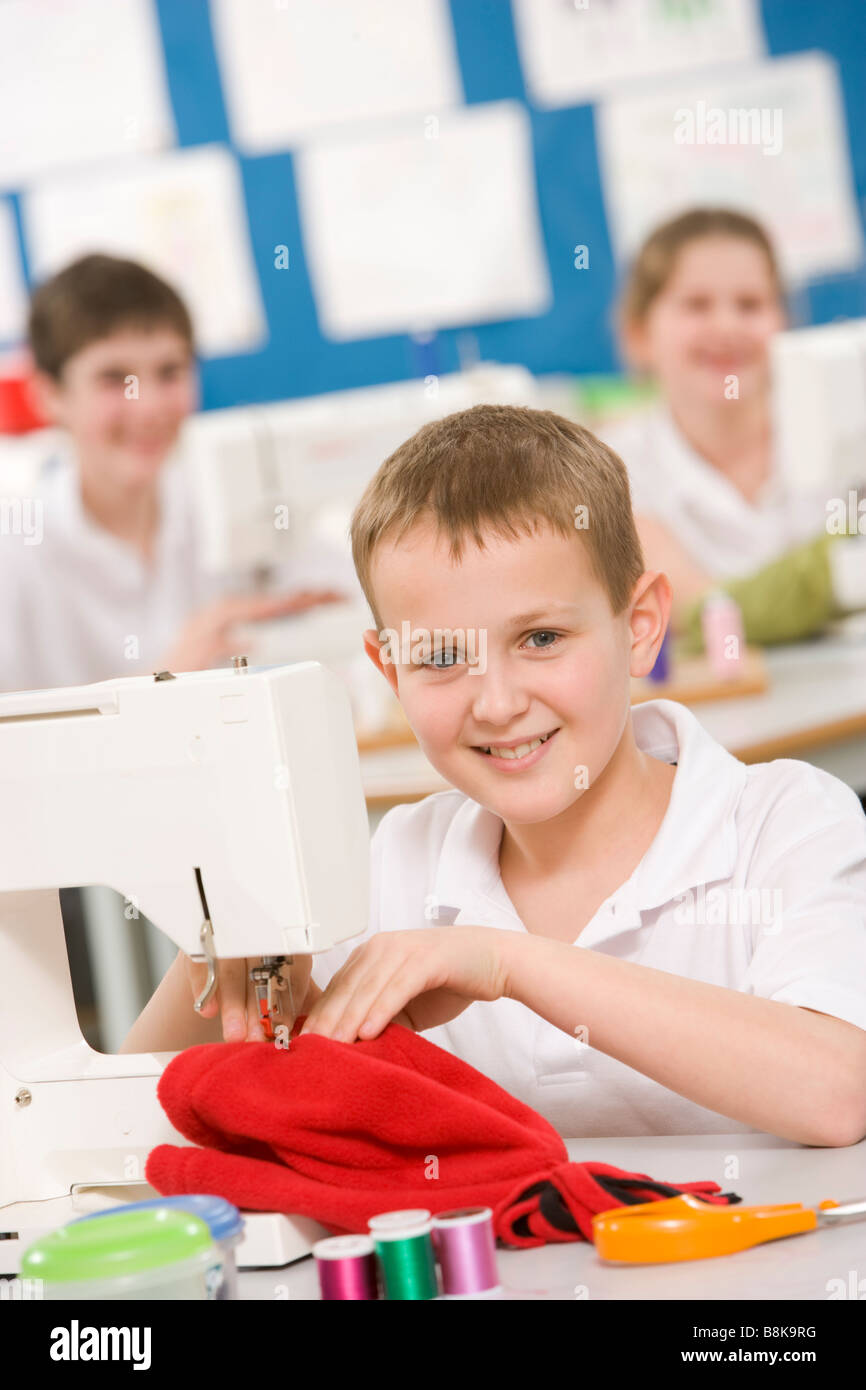 Male student using sewing machine Stock Photo Alamy