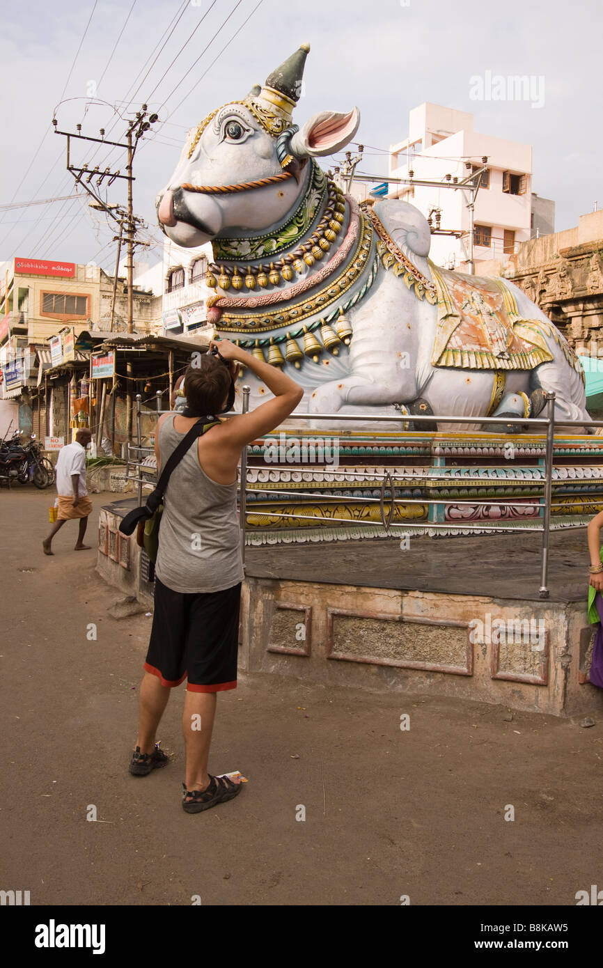 India Tamil Nadu Madurai tourist in singlet photographing large Nandi Stock Photo