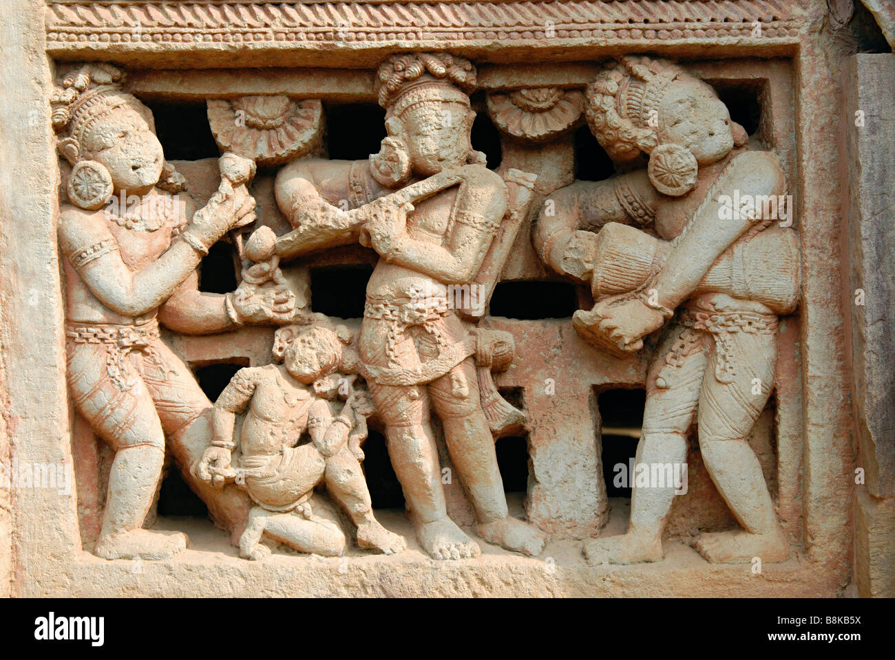 Parasuramesvara Temple, Orissa, Bhubaneshwar, India. Right of main entrance door showing dancing figures with flute player Stock Photo