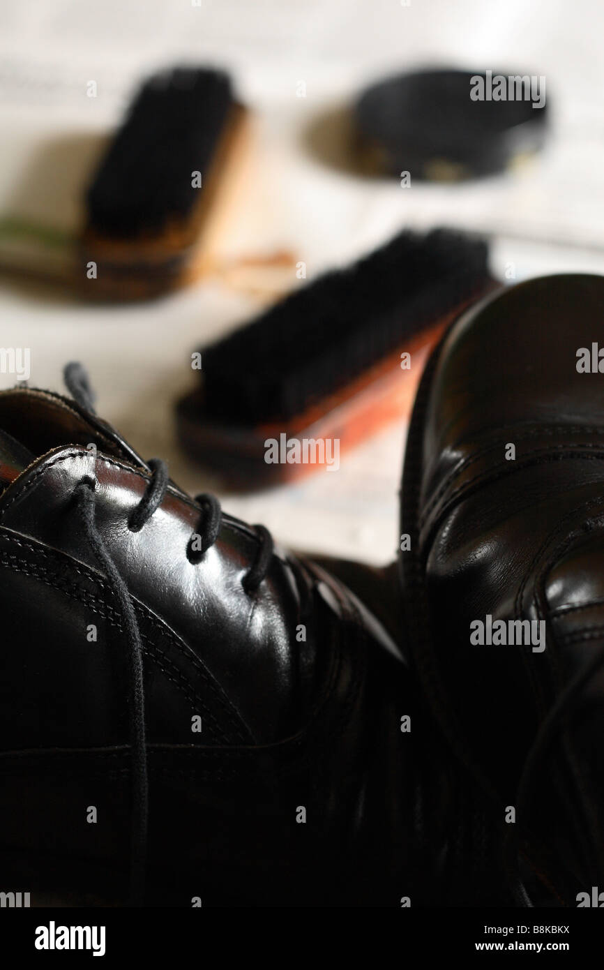 Polishing black shoes with shoe brush and shoe polish Stock Photo Alamy