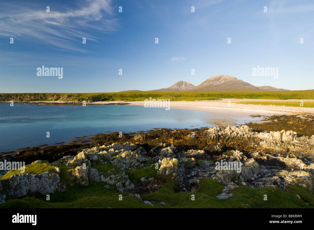 The bay at Inver on the Isle of Jura, looking across a raised beach to the Paps of Jura, Scotland. Stock Photo