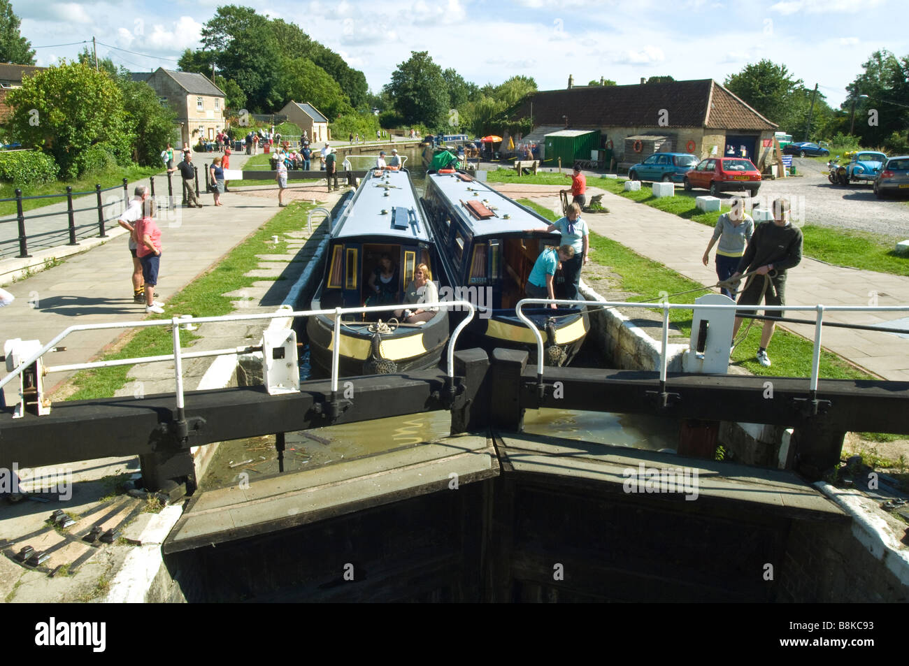 Two narrowboats negotiating the canal lock gates of the Kennet and Avon Canal at Bradford on Avon Wiltshire Stock Photo