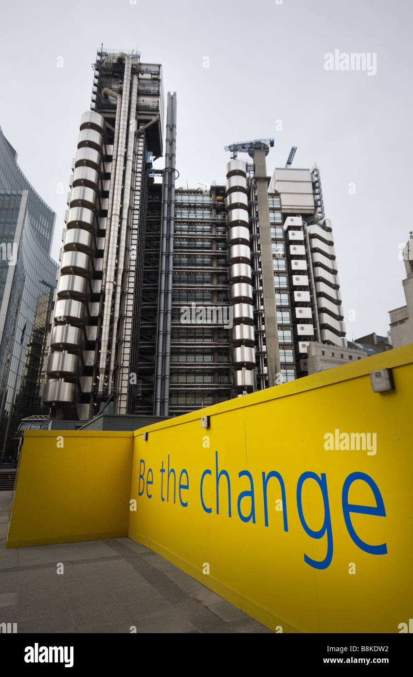 Lloyds building in the City of London, with an advertisement in front which reads, 'Be the change' Stock Photo