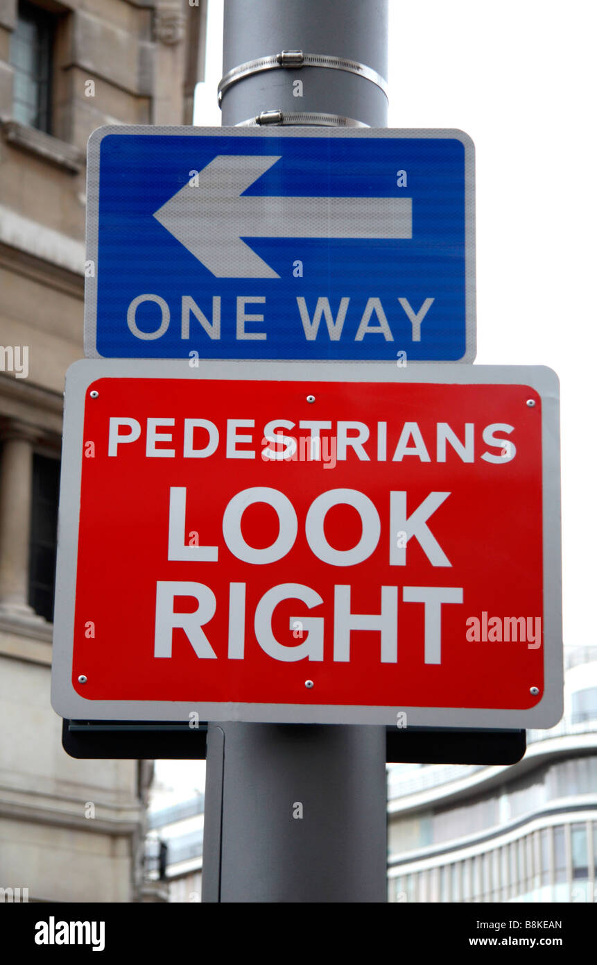 A pair of pedestrian and road street signs outside Sloane Square tube station, London.  Jan 2009 Stock Photo