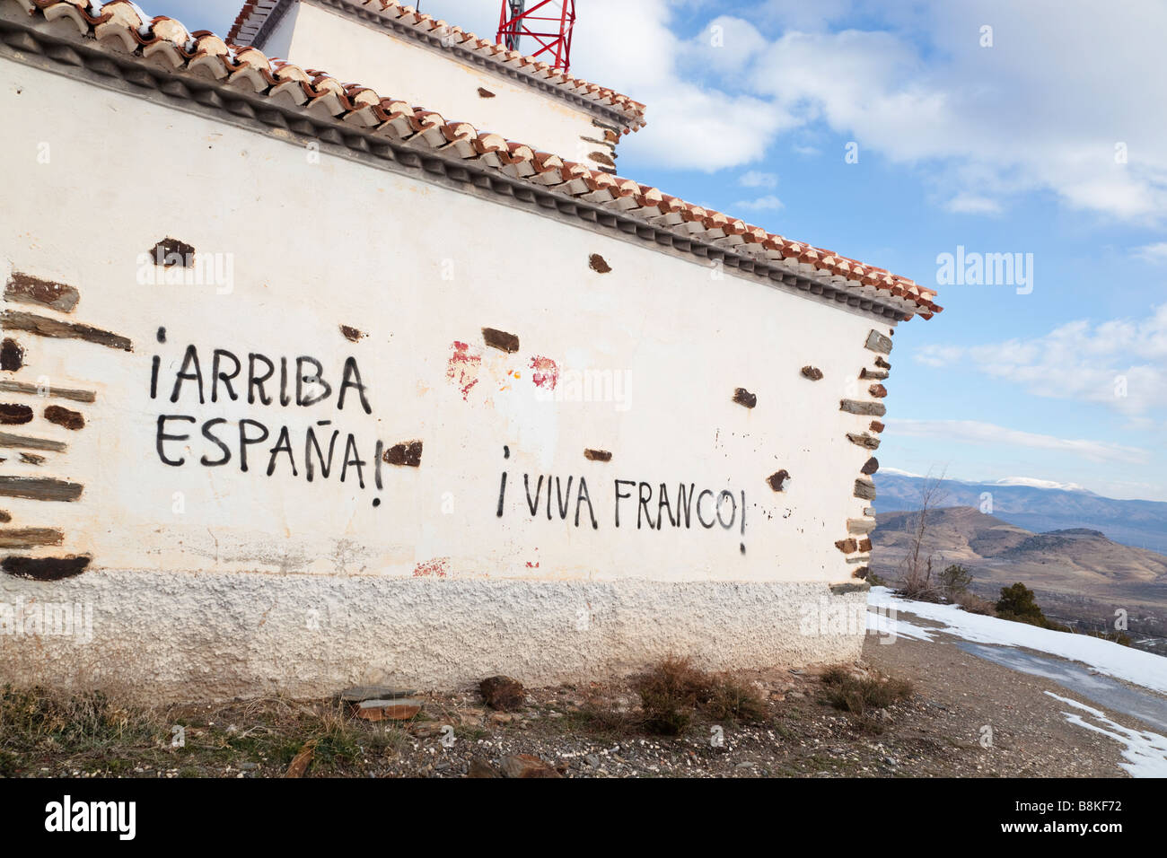 Falangist and Francoist political slogans painted on wall near La Calahorra Granada Province Spain Stock Photo