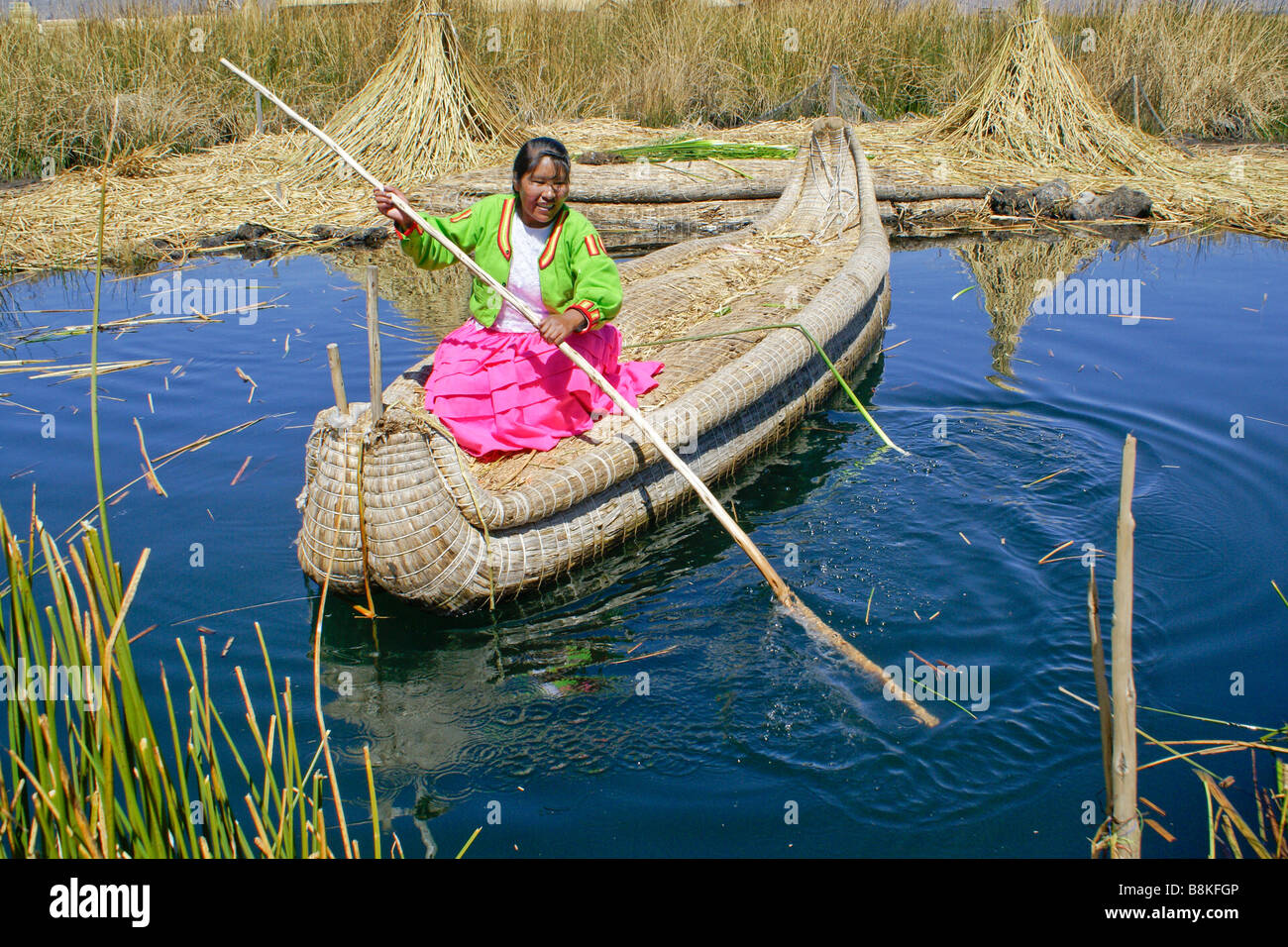 Uros Indian woman poling tortora reed boat with guinea pigs (cuy ...