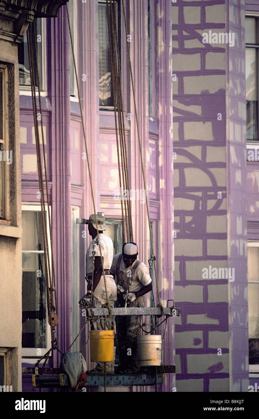 Two Afro-American painters on scaffold painting houses in San Francisco, California. Stock Photo