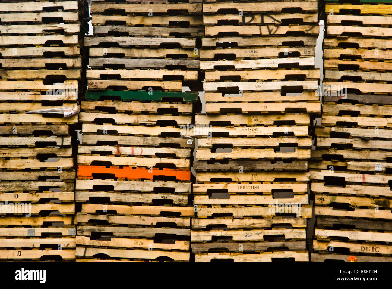 Mountains of cargo pallets stacked behind a trucking depot in downtown